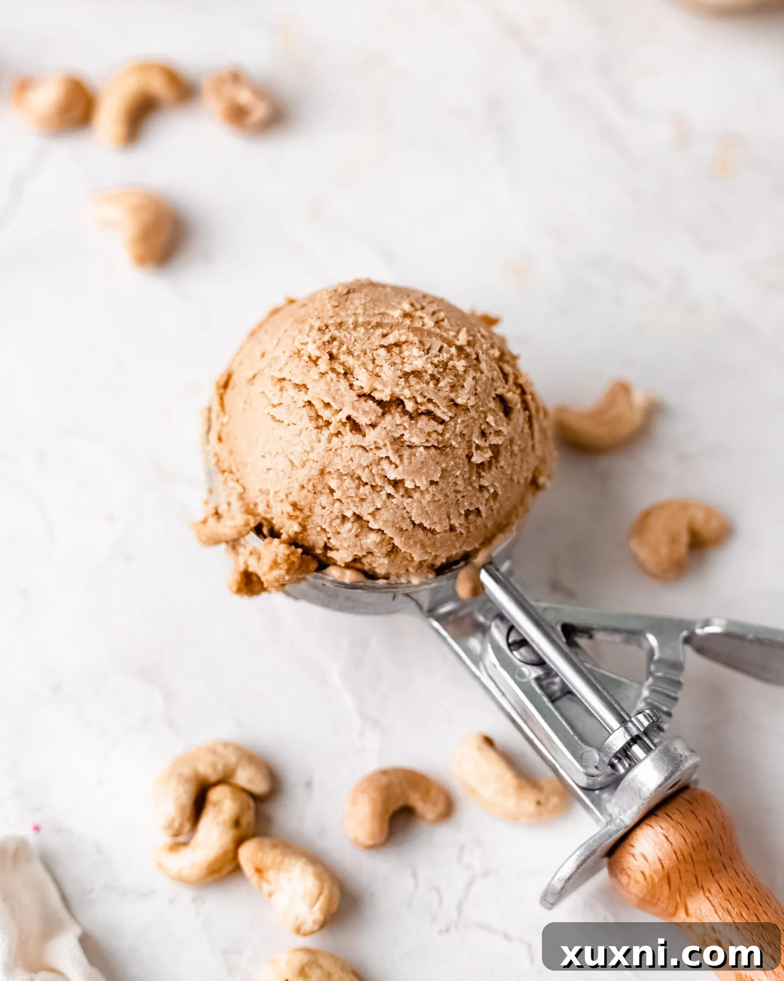 Close-up of a scoop of creamy vanilla ice cream, highlighting its smooth texture.