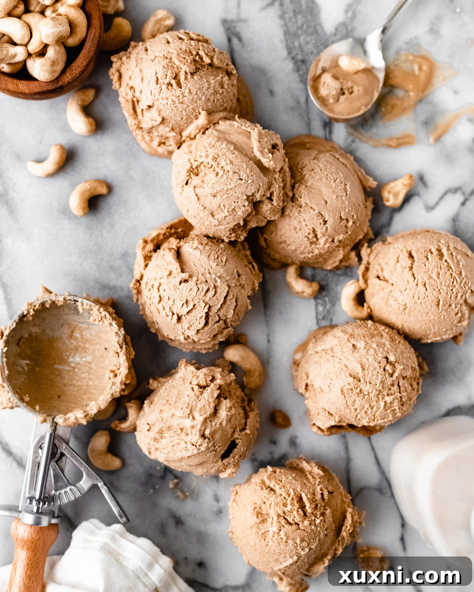 Three generous scoops of creamy vegan vanilla ice cream in a bowl, ready to be enjoyed.
