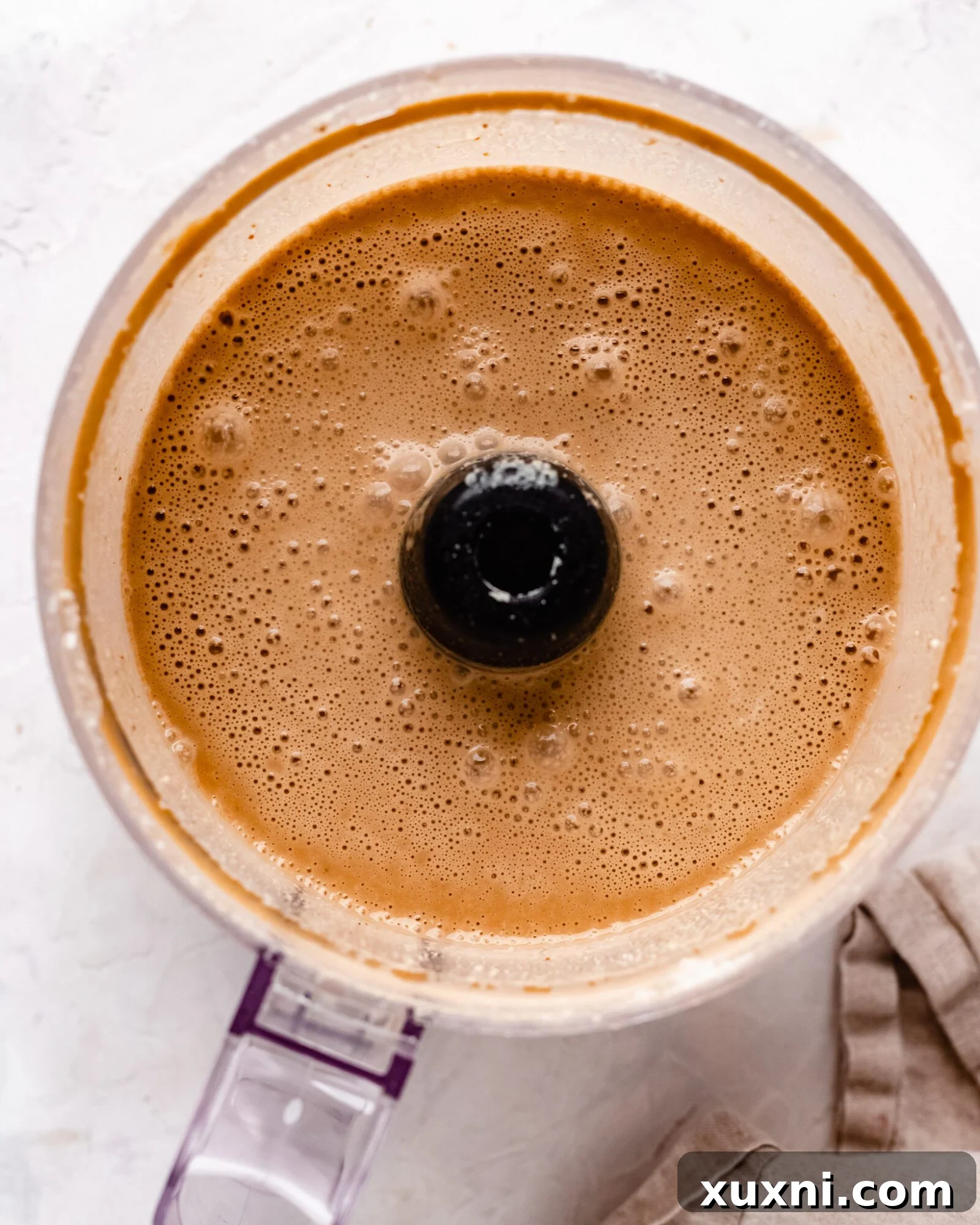 Cashew milk ice cream ingredients blending in a food processor.