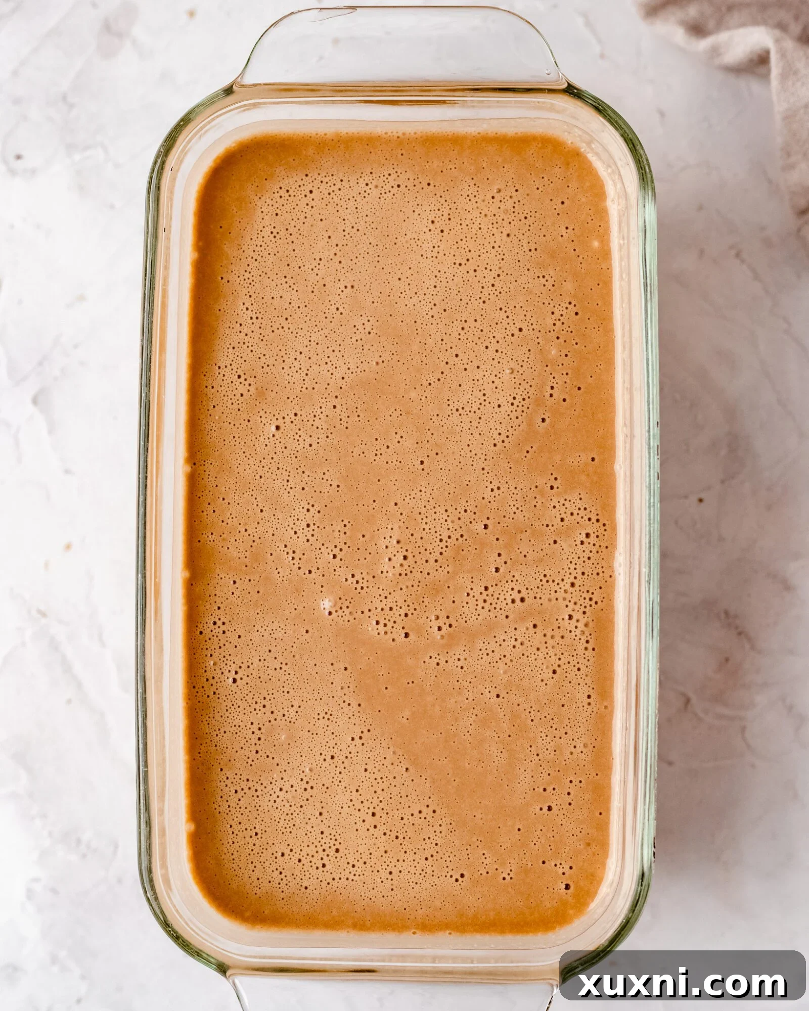 Blended cashew milk ice cream mixture in a container, ready for freezing.