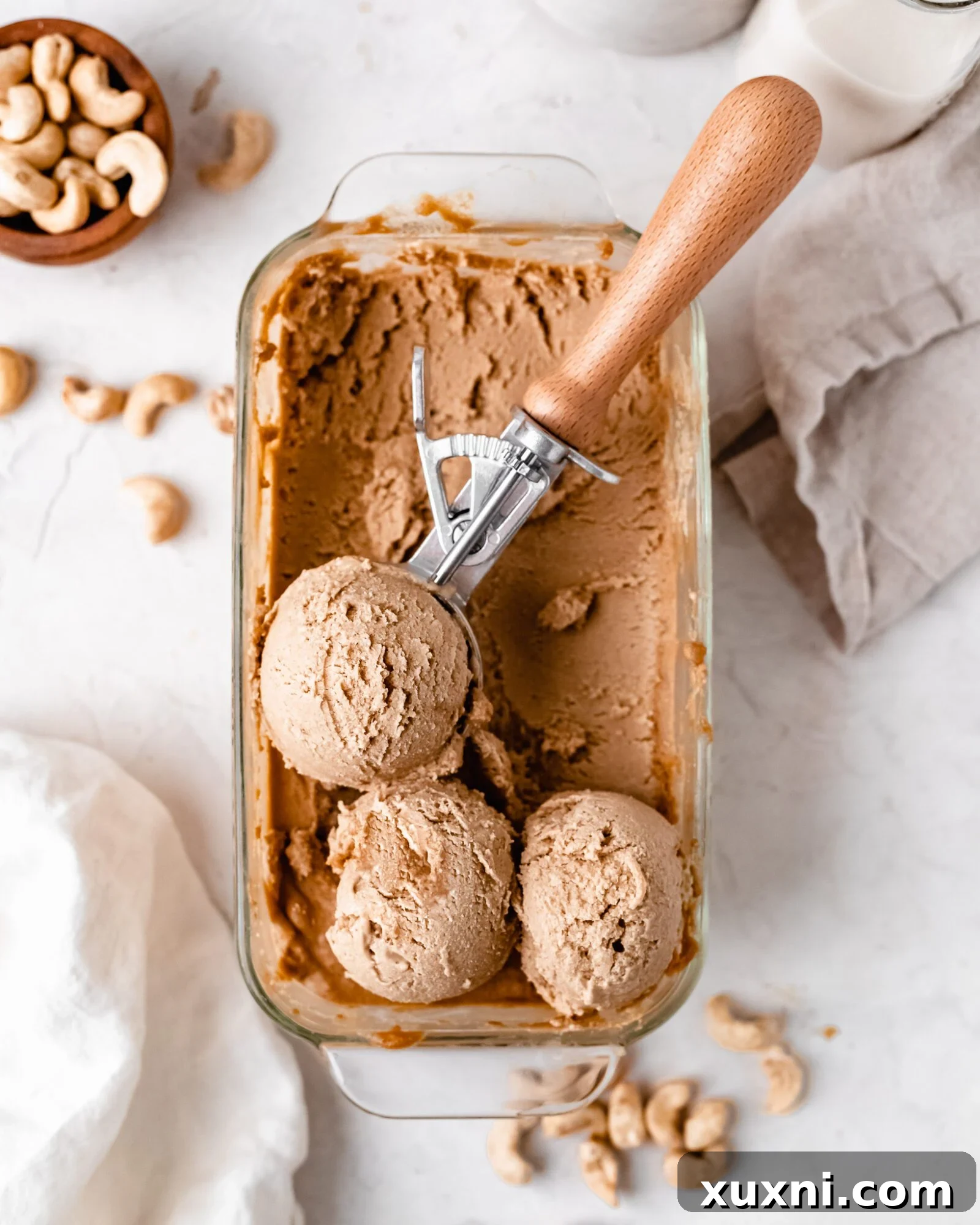 Container of blended cashew milk ice cream, partially frozen, showing the texture before final freeze.