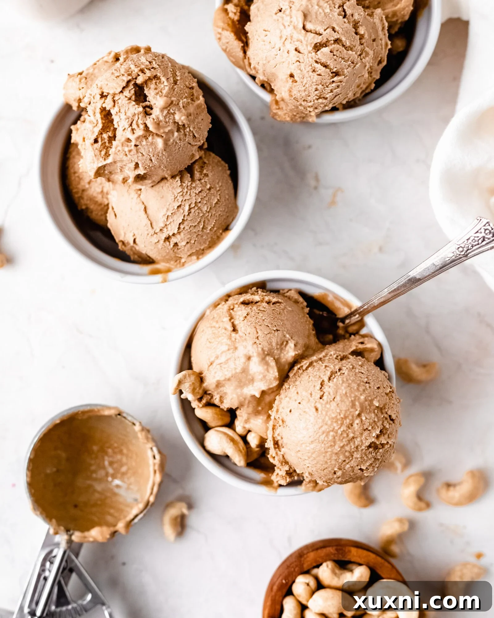Two small cups filled with creamy vegan cashew ice cream, ready to serve.