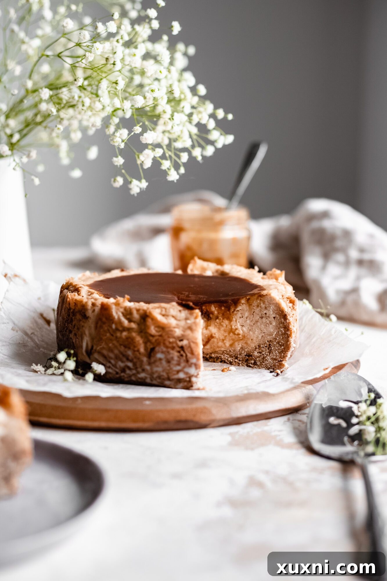 baked cheesecake on wooden board with serving spoon