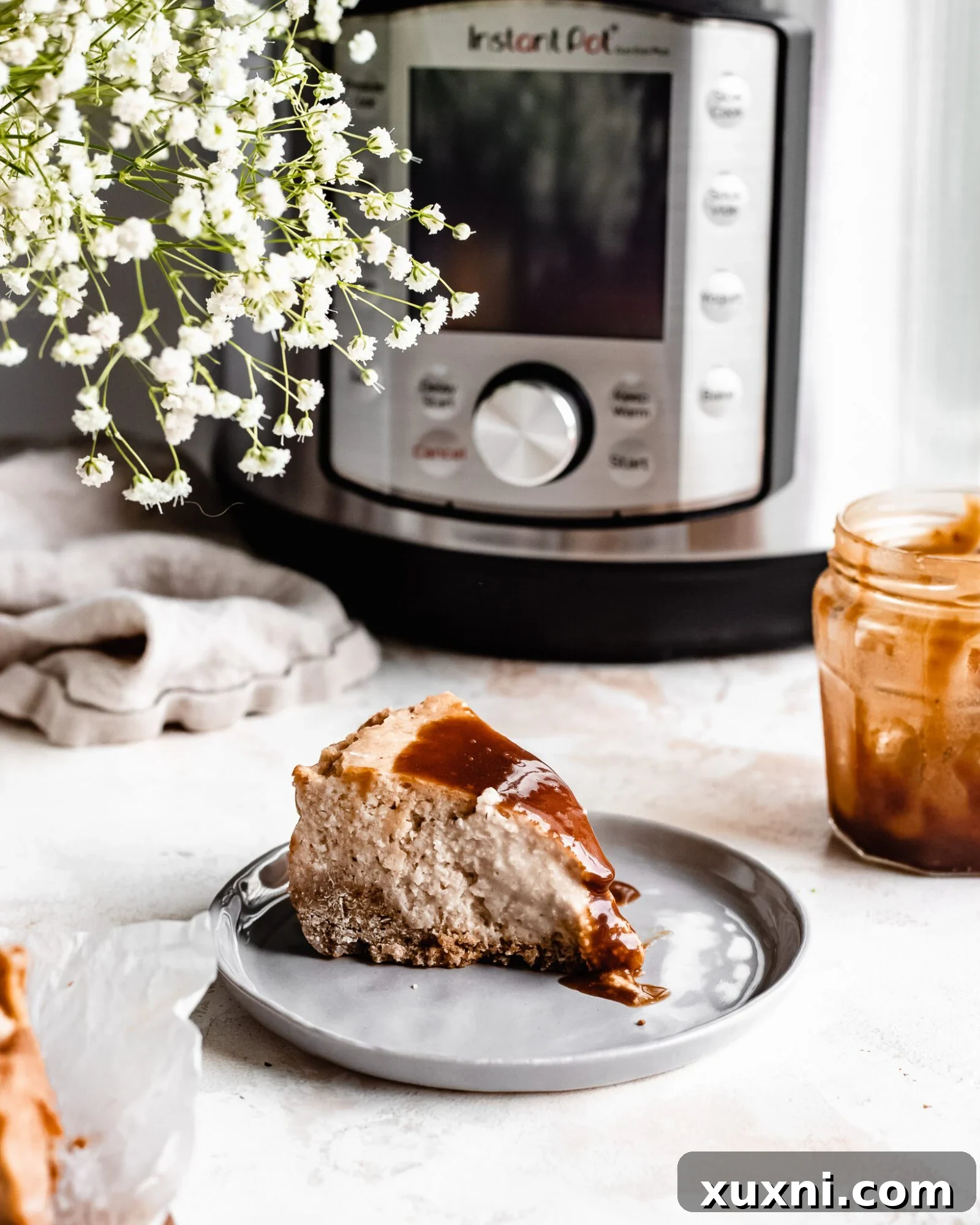 slice of vegan cheesecake with caramel sauce on plate