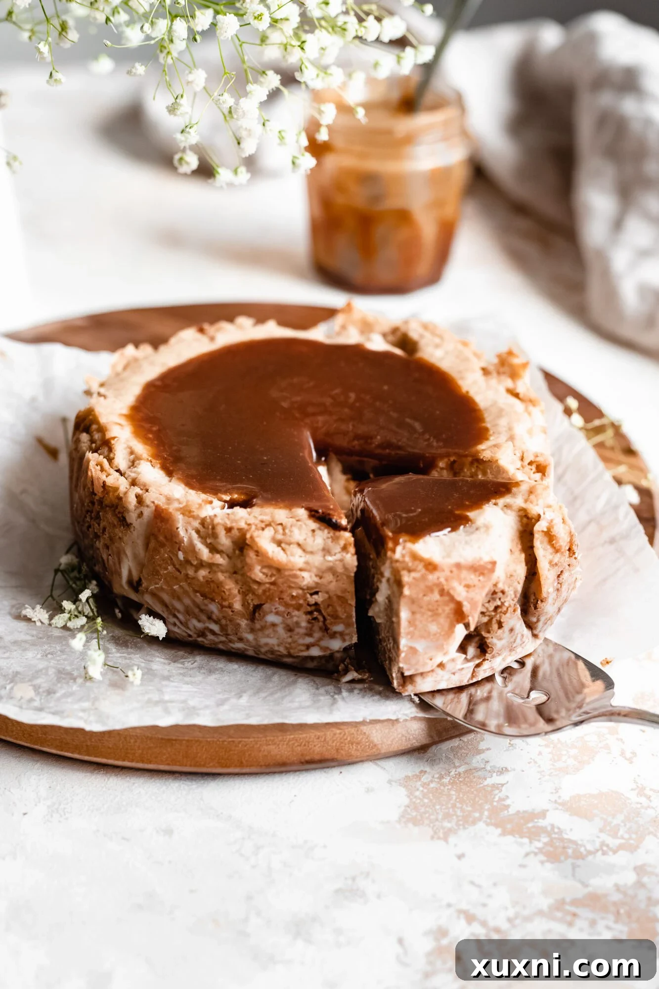 single slice of cheesecake being pulled from whole cake