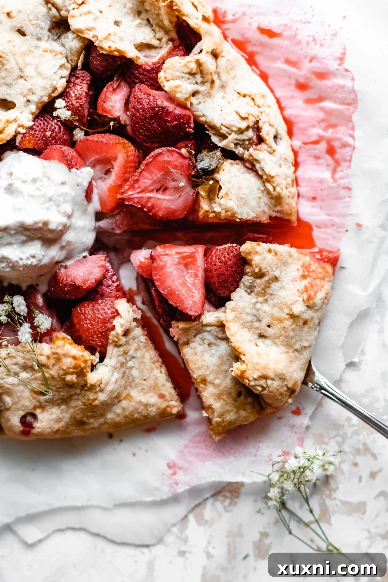 A freshly baked strawberry galette, cut into generous slices, ready for serving