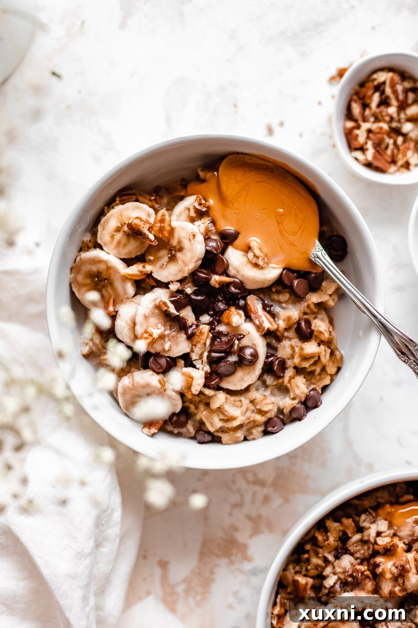 Instant Pot Protein Packed Vegan Zucchini Oatmeal 13 bowl of zucchini oatmeal with bananas, peanut butter, and chocolate chips mixed in