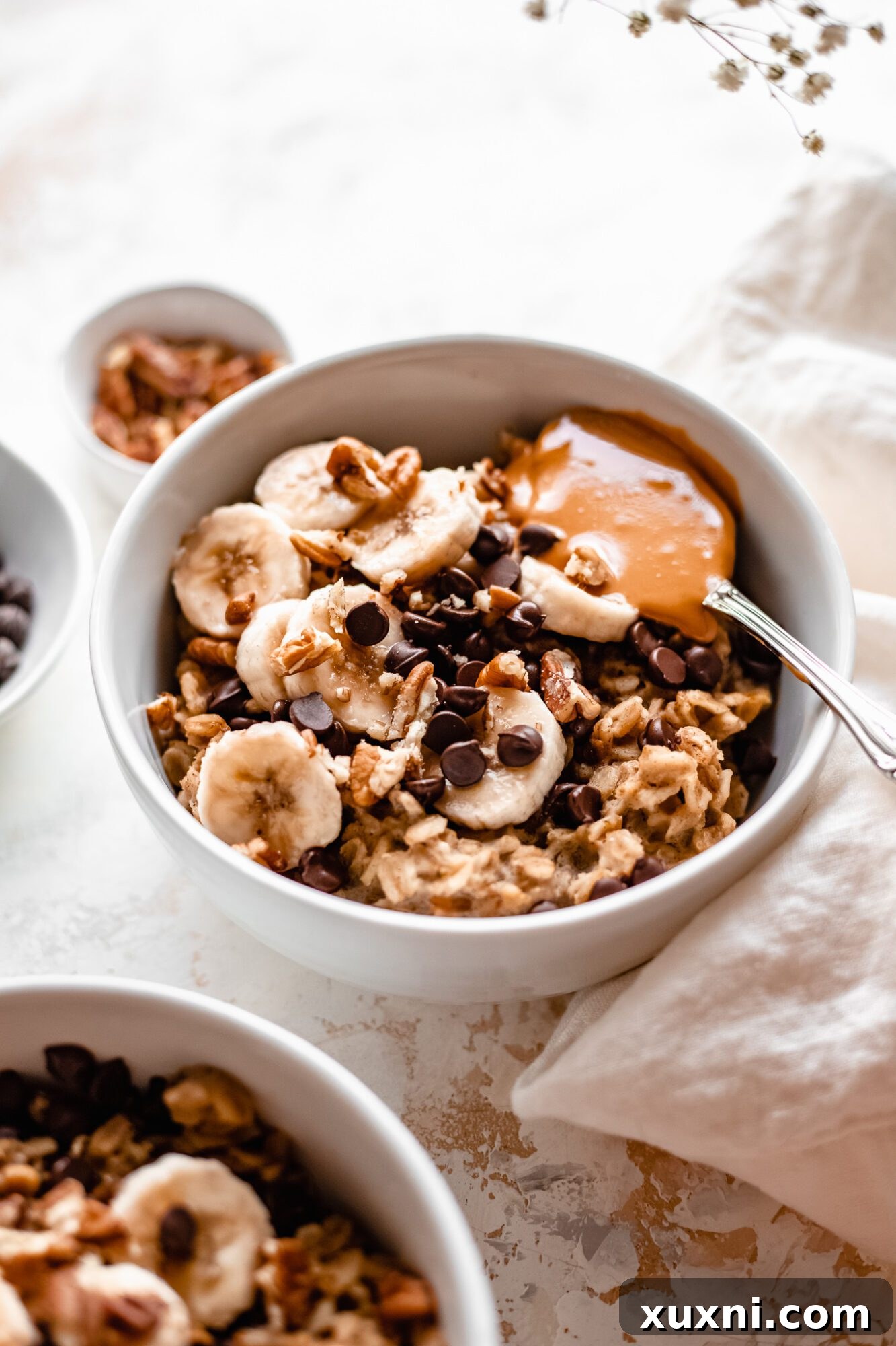 Instant Pot Protein Packed Vegan Zucchini Oatmeal 3 multiple bowls of zucchini oatmeal with chocolate chips and other various toppings