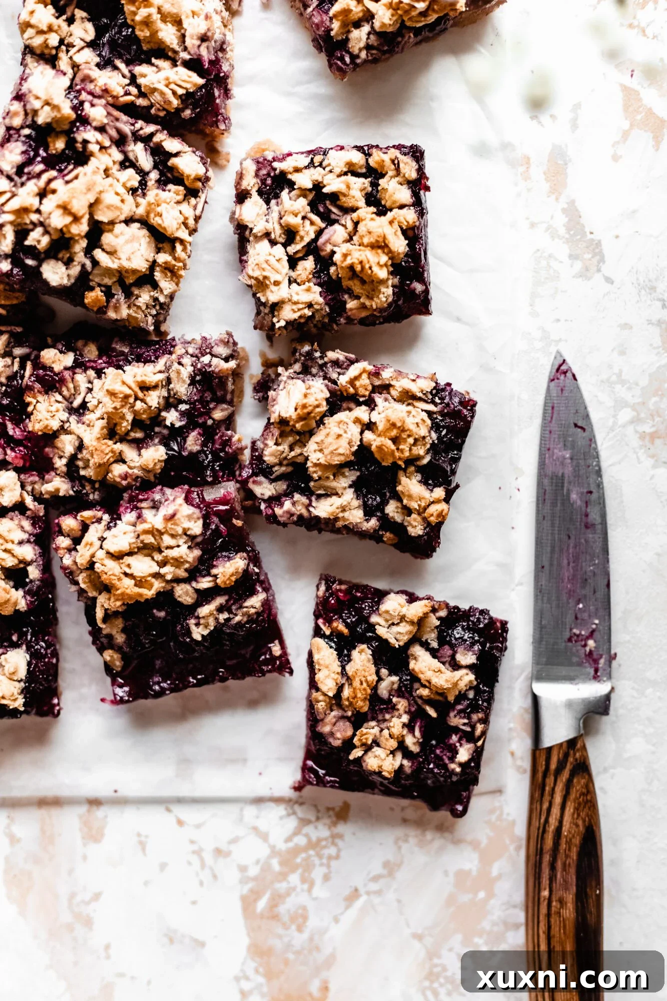 A beautiful stack of perfectly sliced blueberry bars, ready to be served.