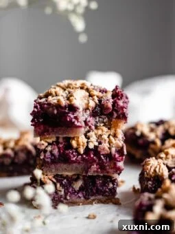 Stacked healthy blueberry crumble bars, perfect for a vegan and gluten-free dessert.