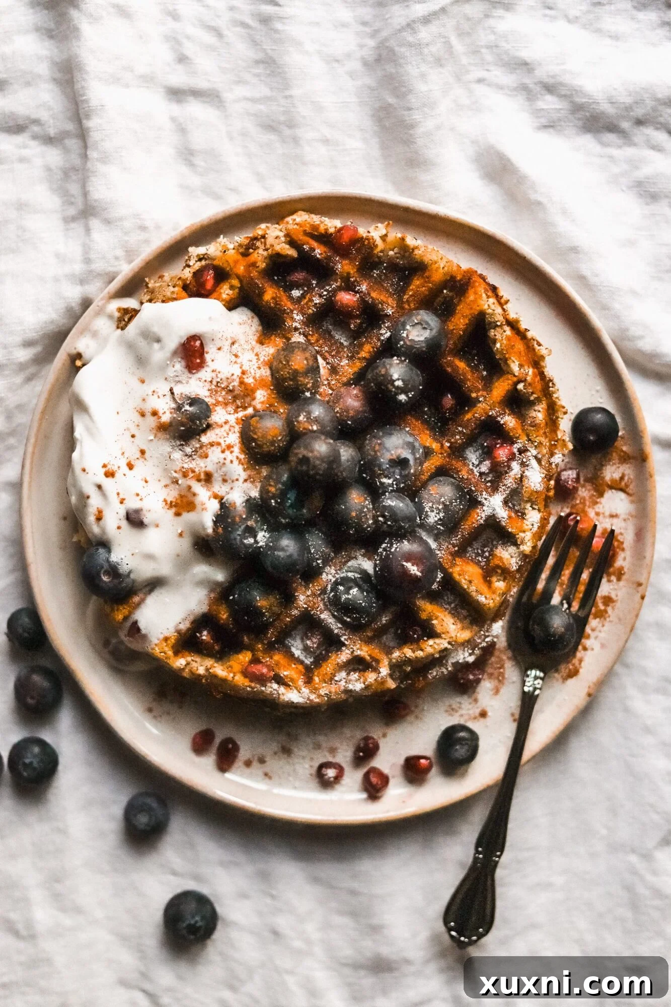 plate of paleo waffles with coconut cream