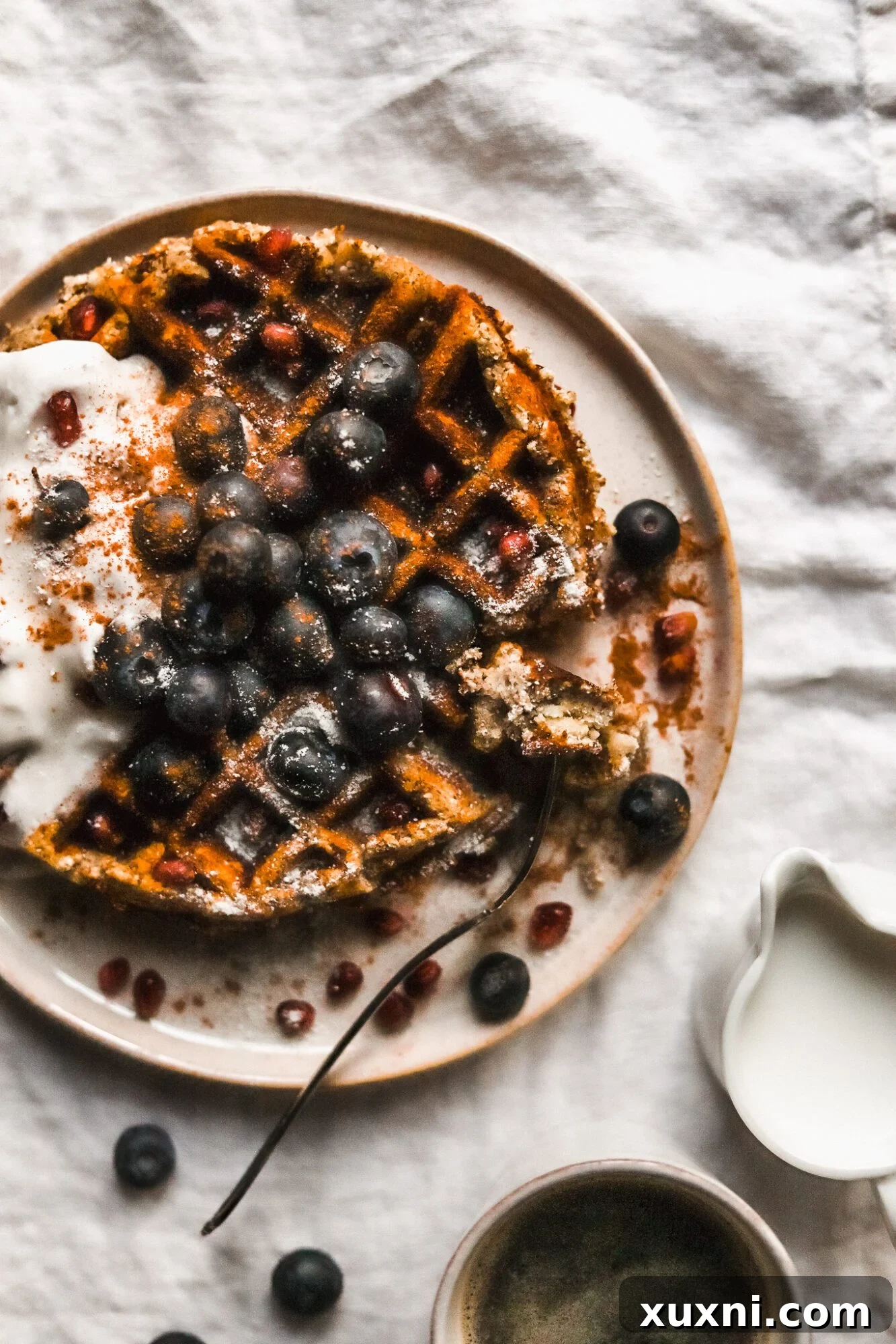 fork taking piece of waffle