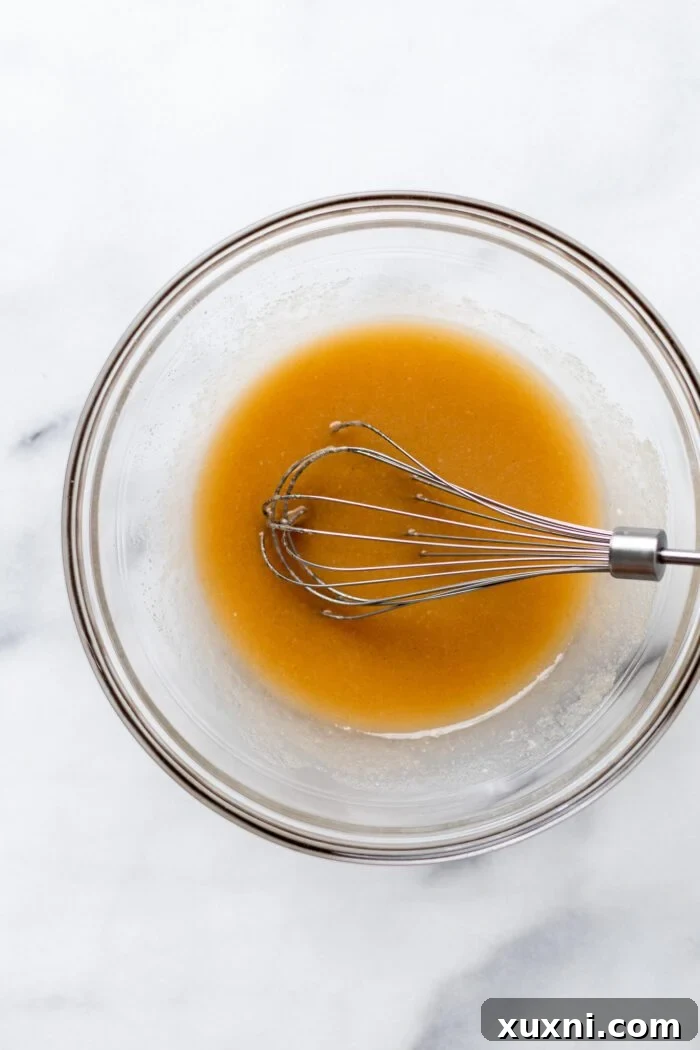 Liquid ingredients for vegan vanilla cupcakes in a bowl, after being whisked