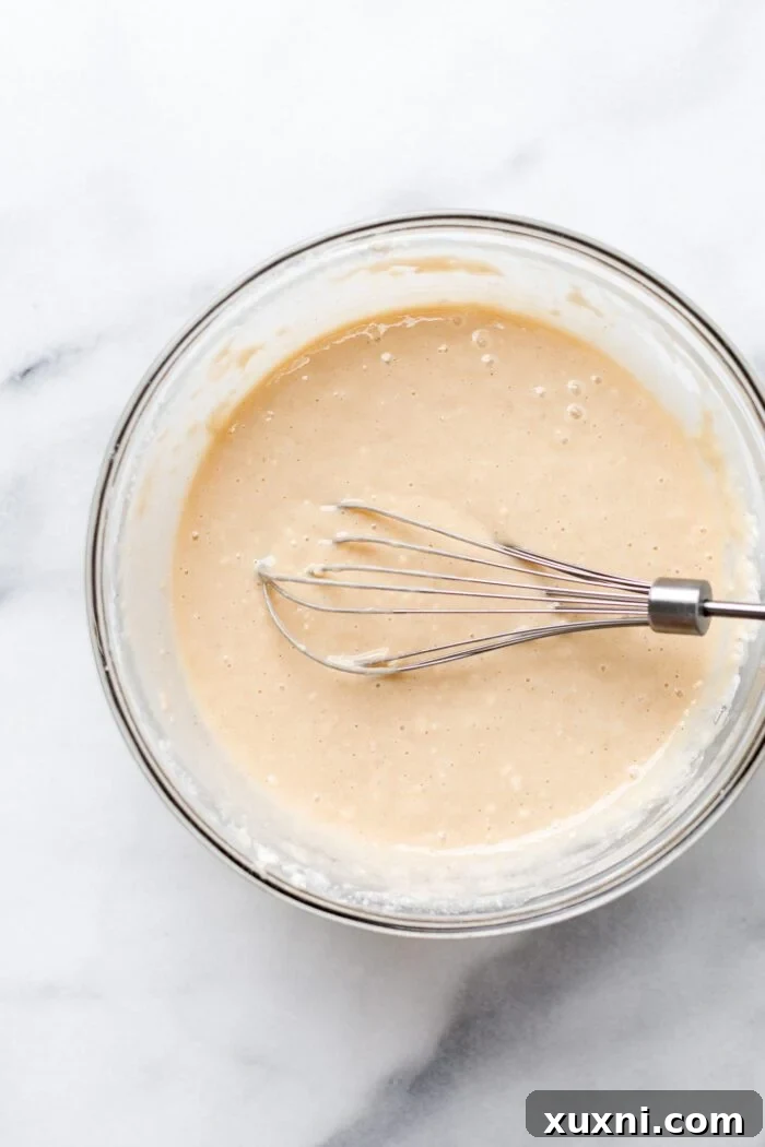 Smooth vegan vanilla cupcake batter in a bowl, perfectly mixed