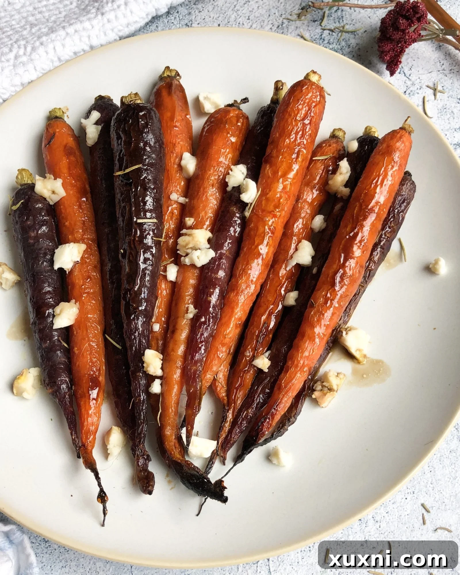 Paleo vegan maple balsamic glazed carrots roasted to perfection, showcasing their vibrant colors and glistening glaze. The perfect healthy side dish for fall and holiday meals.