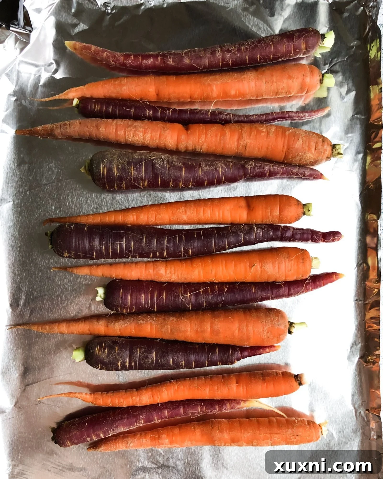 Close-up of roasted paleo vegan maple balsamic glazed carrots, perfectly caramelized and ready to serve for a wholesome fall or holiday meal.