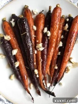 A plate of perfectly glazed maple balsamic carrots, garnished with fresh herbs, showcasing a delicious and healthy side dish.