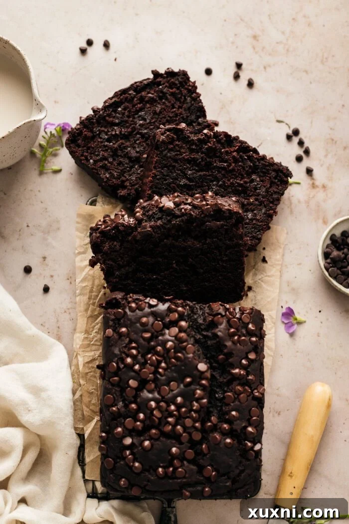 Deliciously moist vegan chocolate zucchini bread sliced, revealing its rich chocolate color and tender texture, perfect for a healthy gluten-free treat.