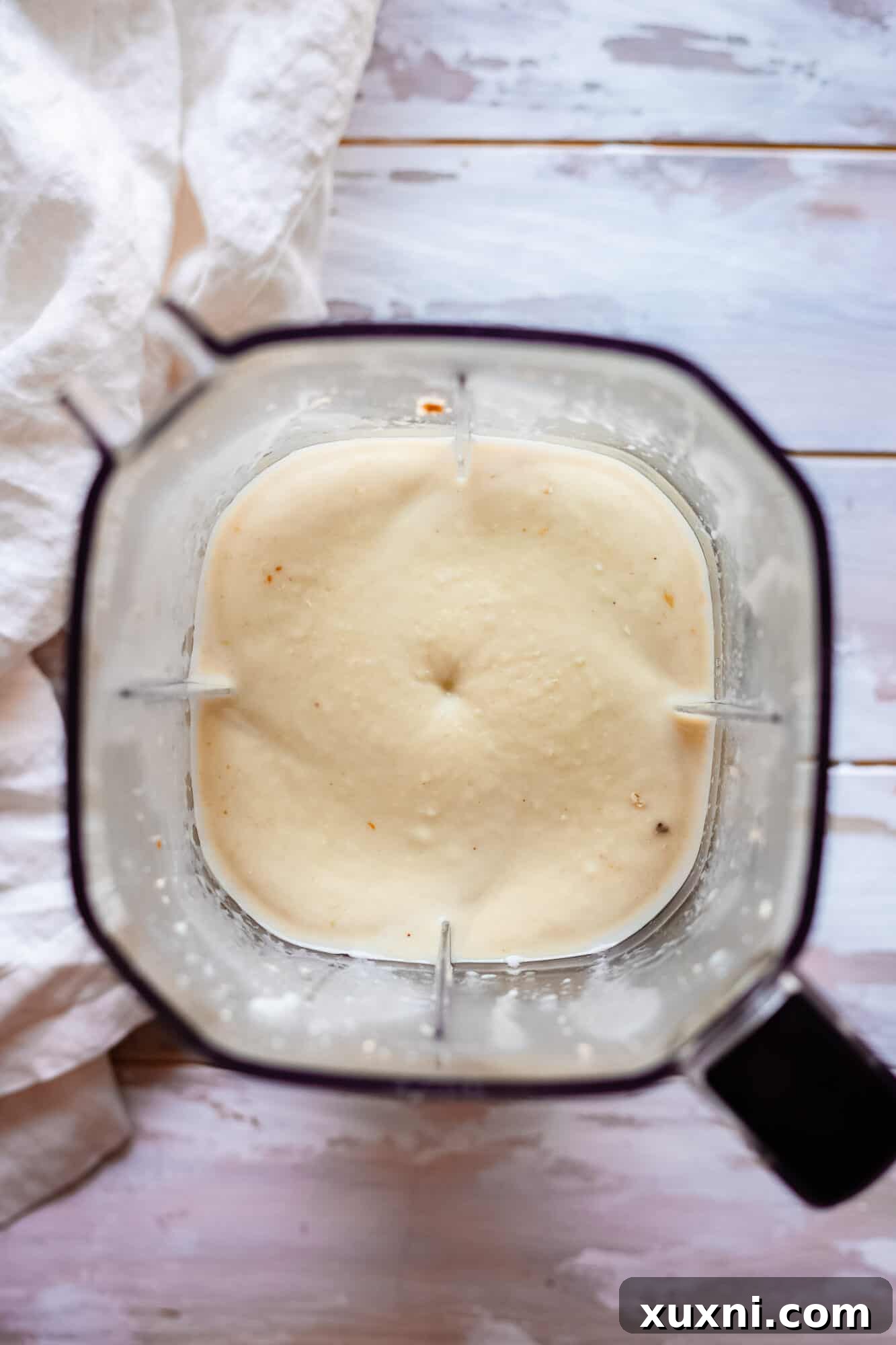 Vegan lemon custard filling blended smooth, showcasing its readiness for the tart.