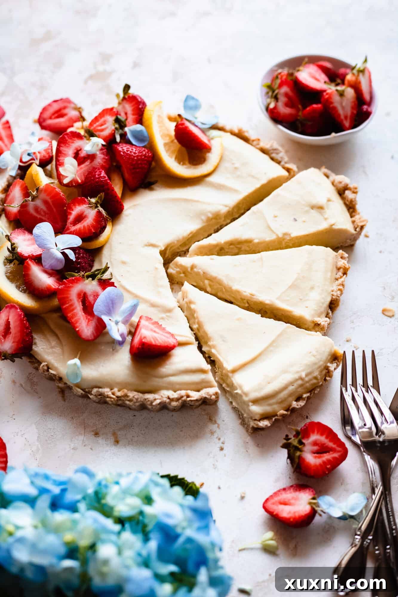 Several slices of vegan lemon custard tart arranged beautifully on a serving plate.