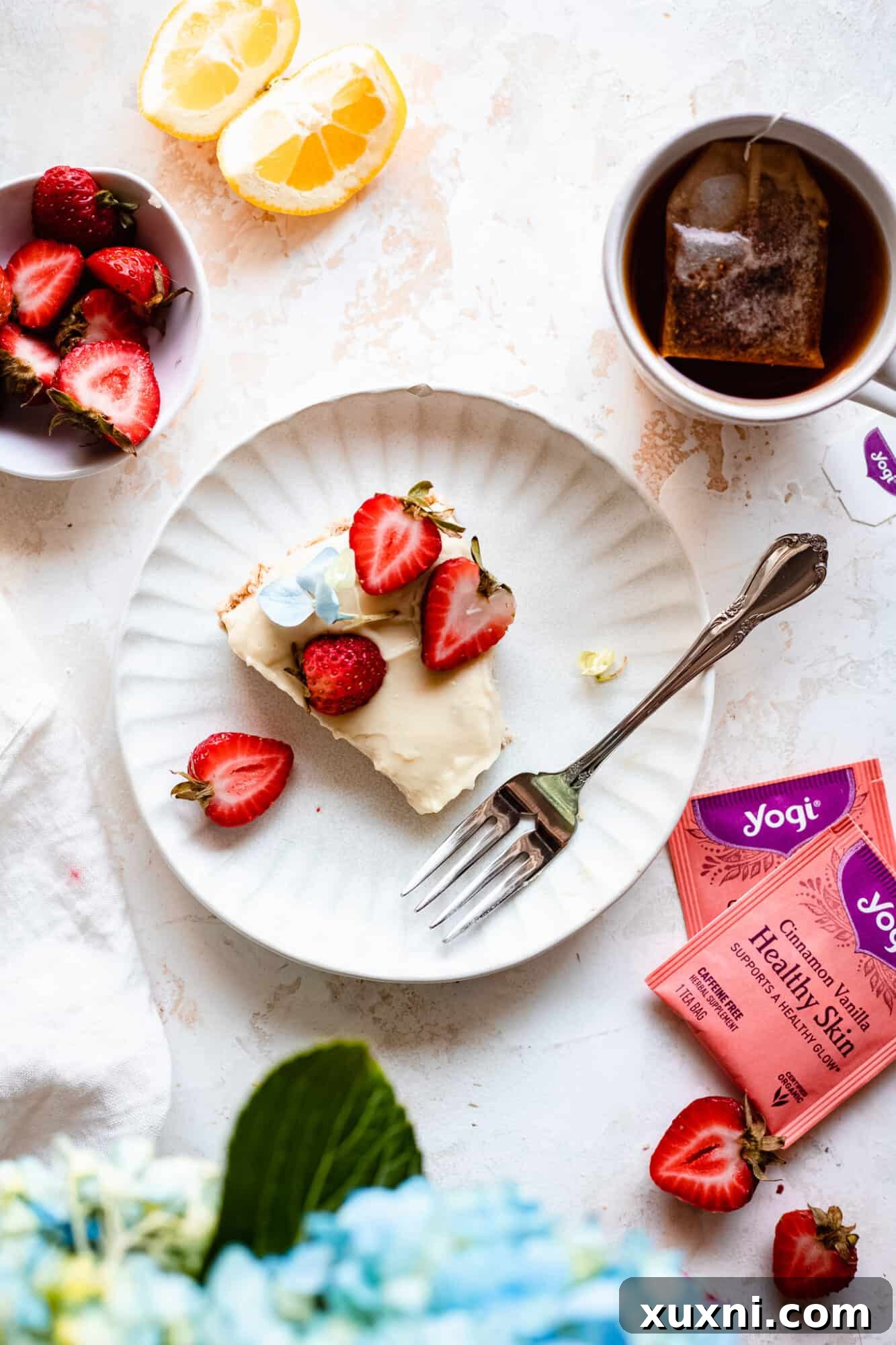 An eaten slice of vegan lemon tart on a plate, showing a bite taken, emphasizing its deliciousness.
