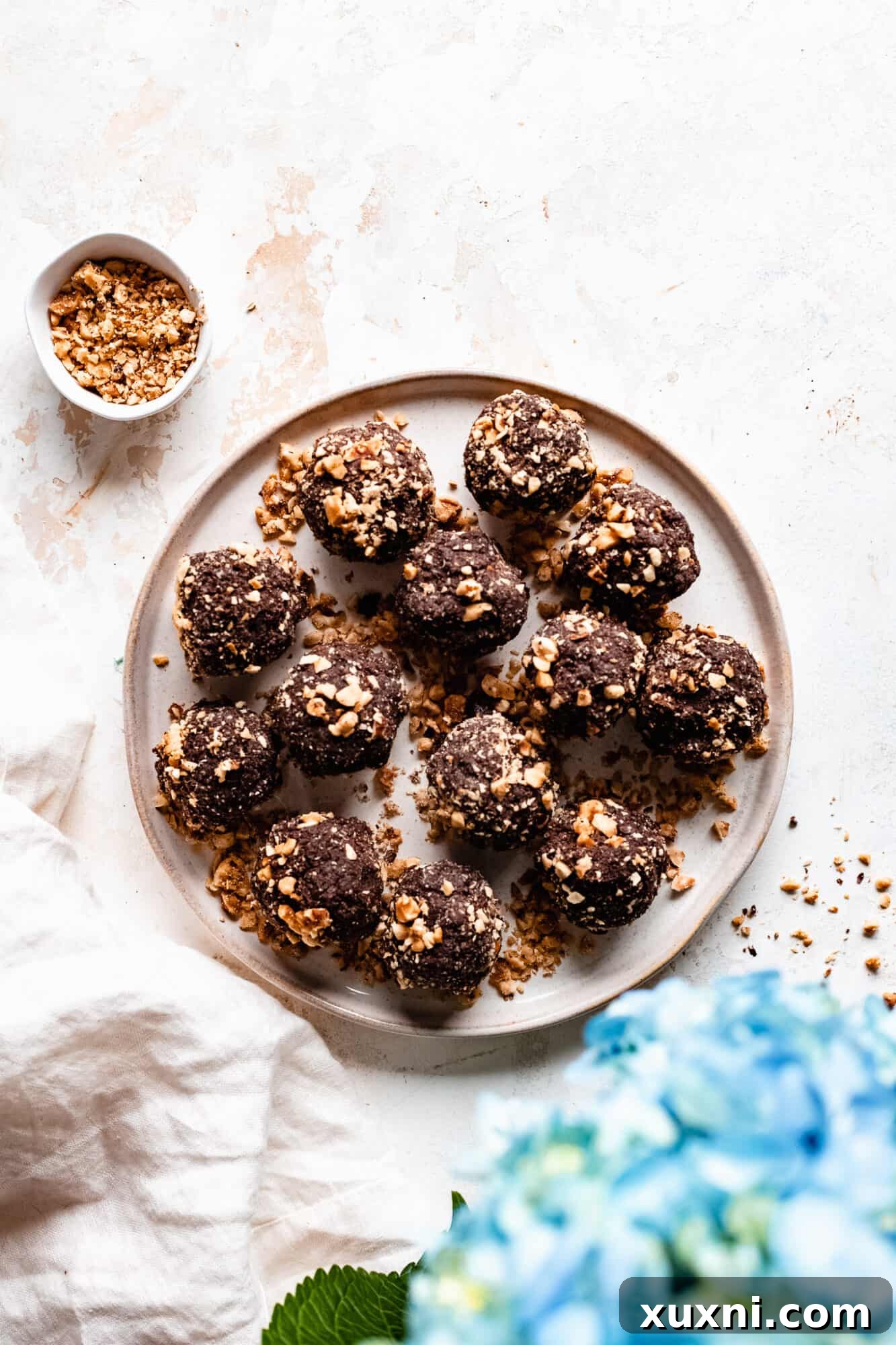A plate overflowing with delicious, round chocolate hazelnut energy balls, ready to be enjoyed.