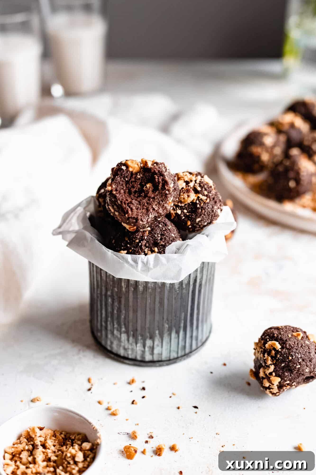A metal tin filled to the brim with chocolate hazelnut energy bites, perfectly portioned for snacking.