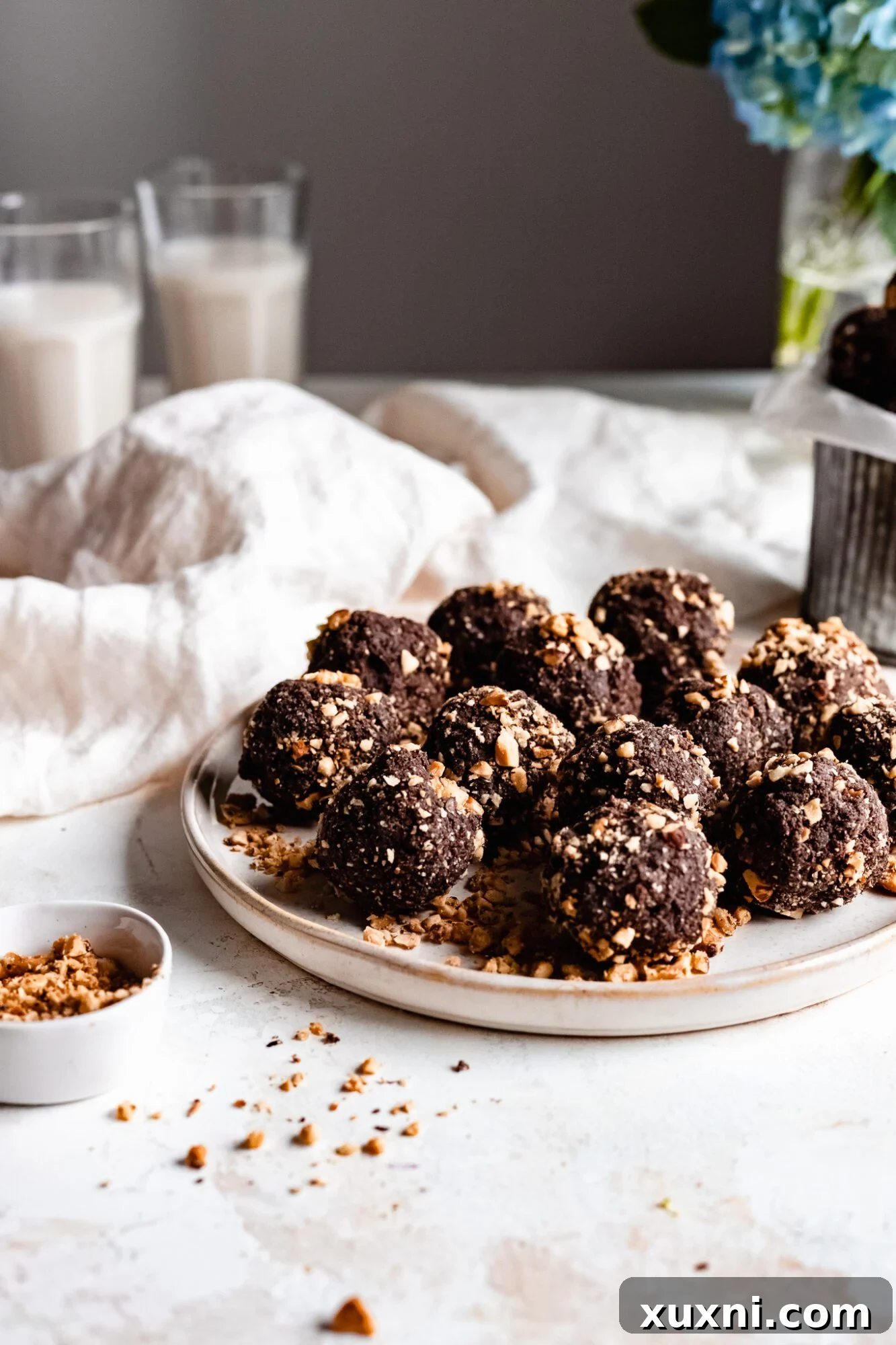A close-up shot of several chocolate hazelnut energy bites, perfectly formed and ready for a bite.