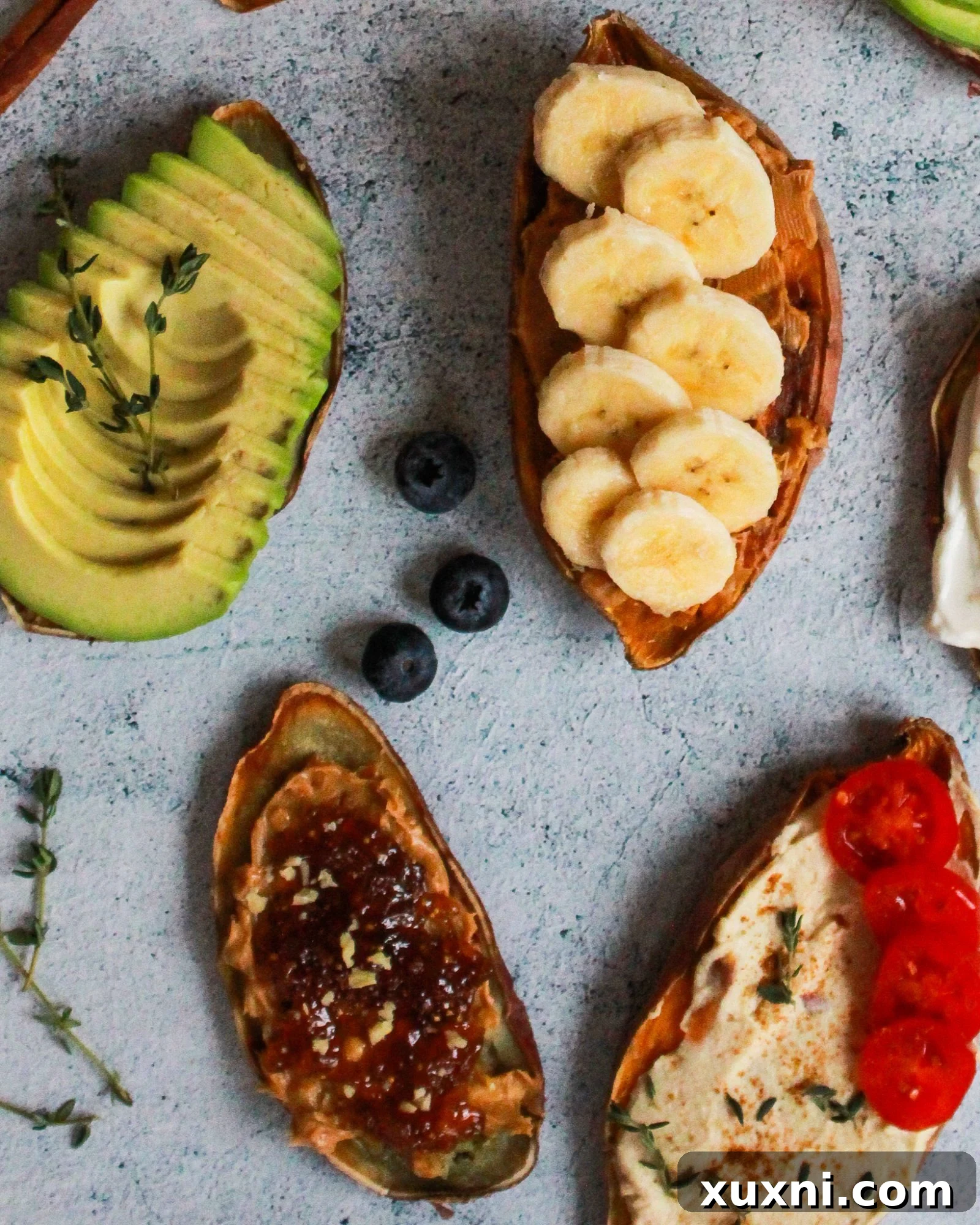 Sweet Potato Toast Reinvented: 5 Vegan Recipes 4 Sweet potato toast topped with vibrant hummus and fresh tomato slices, garnished with herbs.