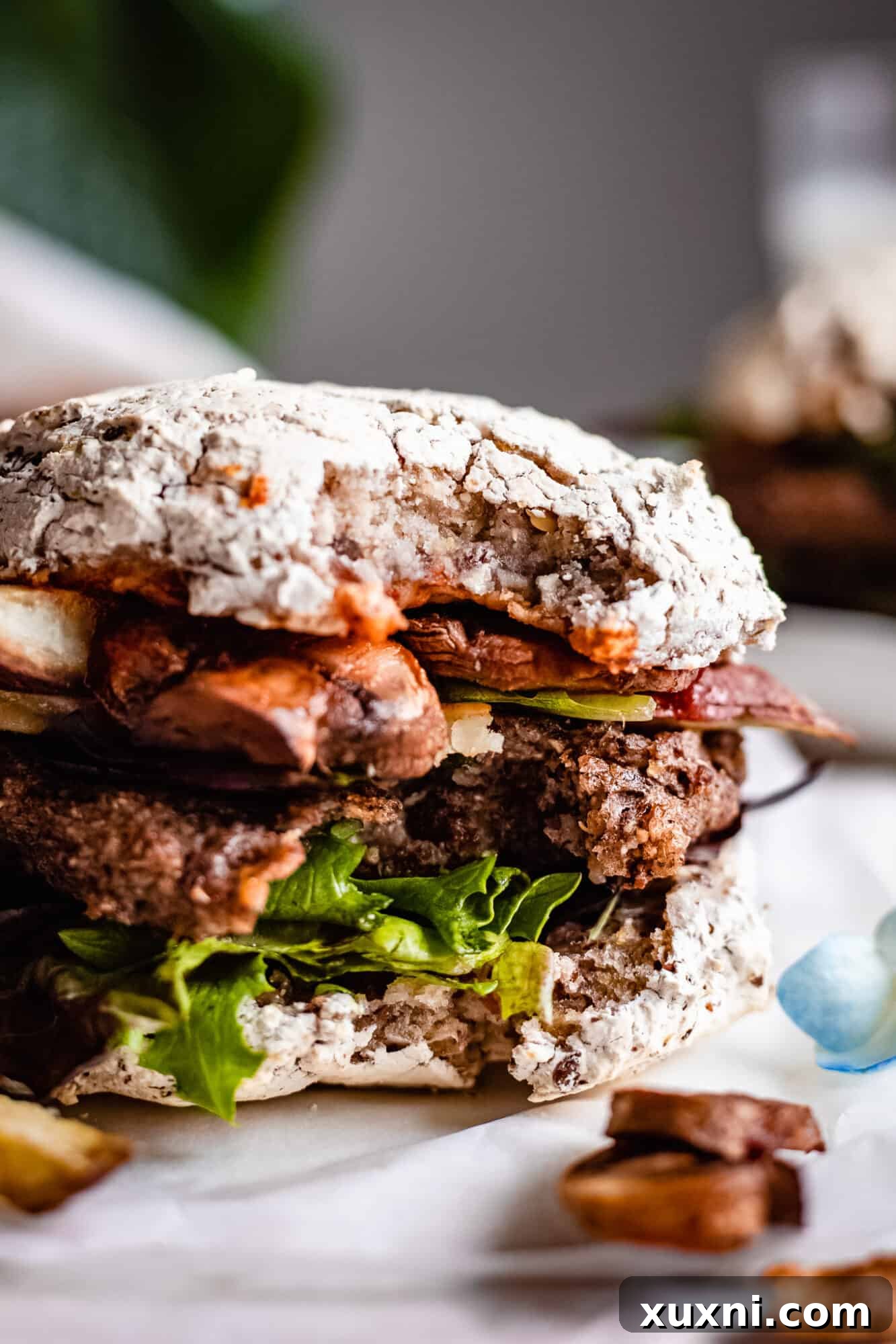 Close-up of a perfectly cooked mushroom quinoa veggie burger with a bite taken, revealing its delicious interior.