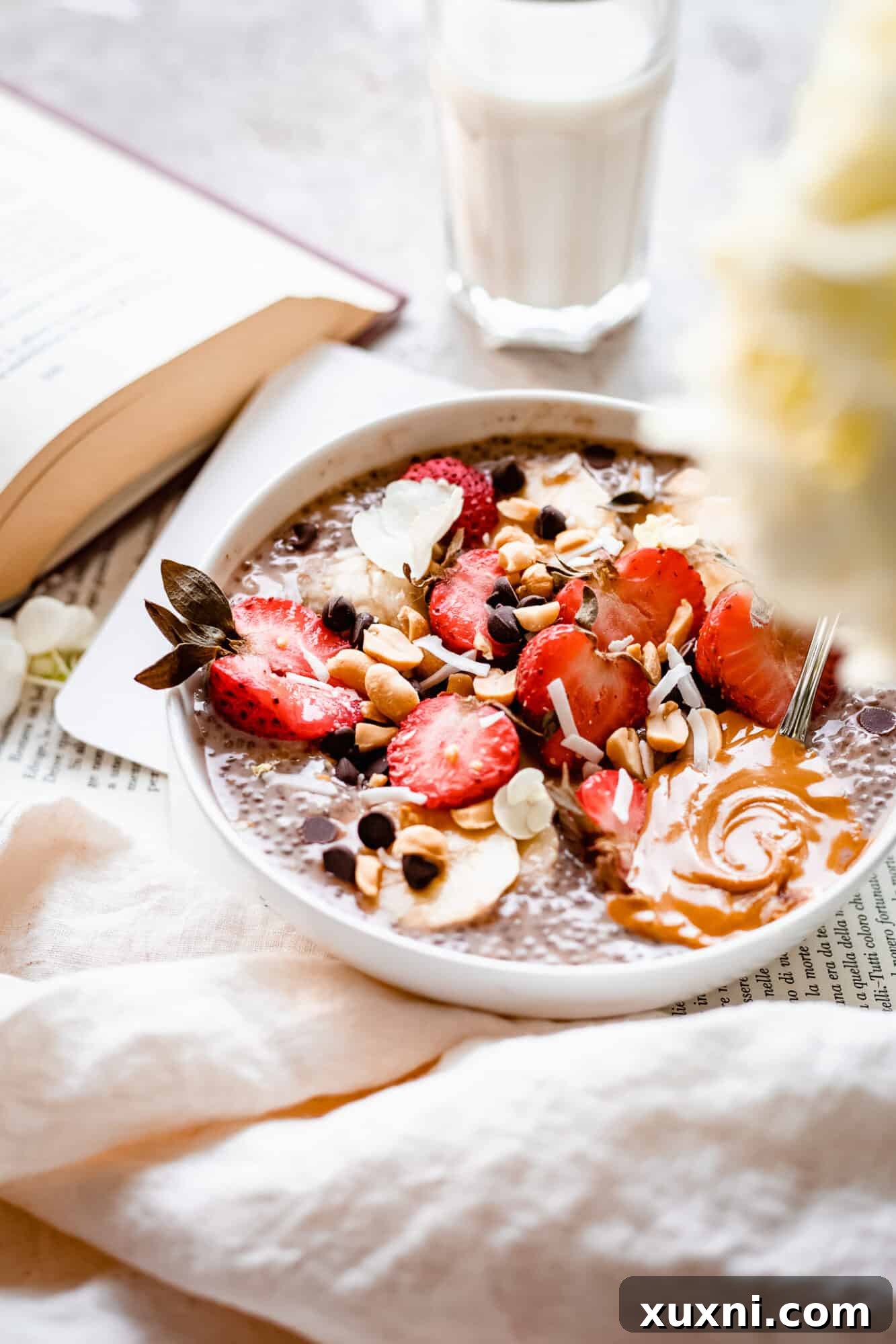 Bowl of chia pudding with a glass of coconut milk, ready for enjoyment