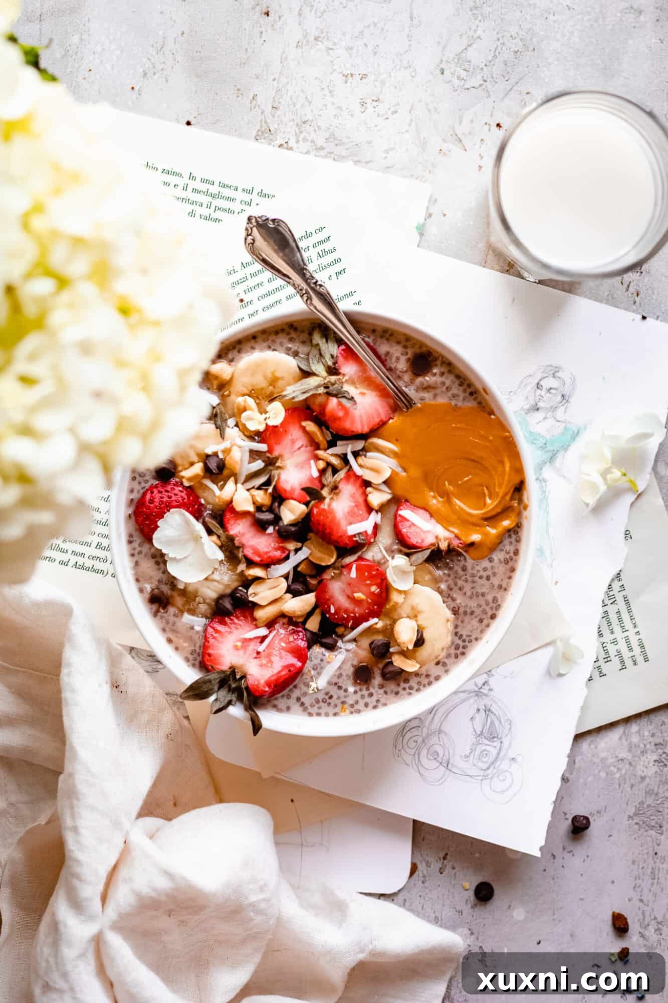A rustic-style shot of a bowl of chia pudding on open recipe pages