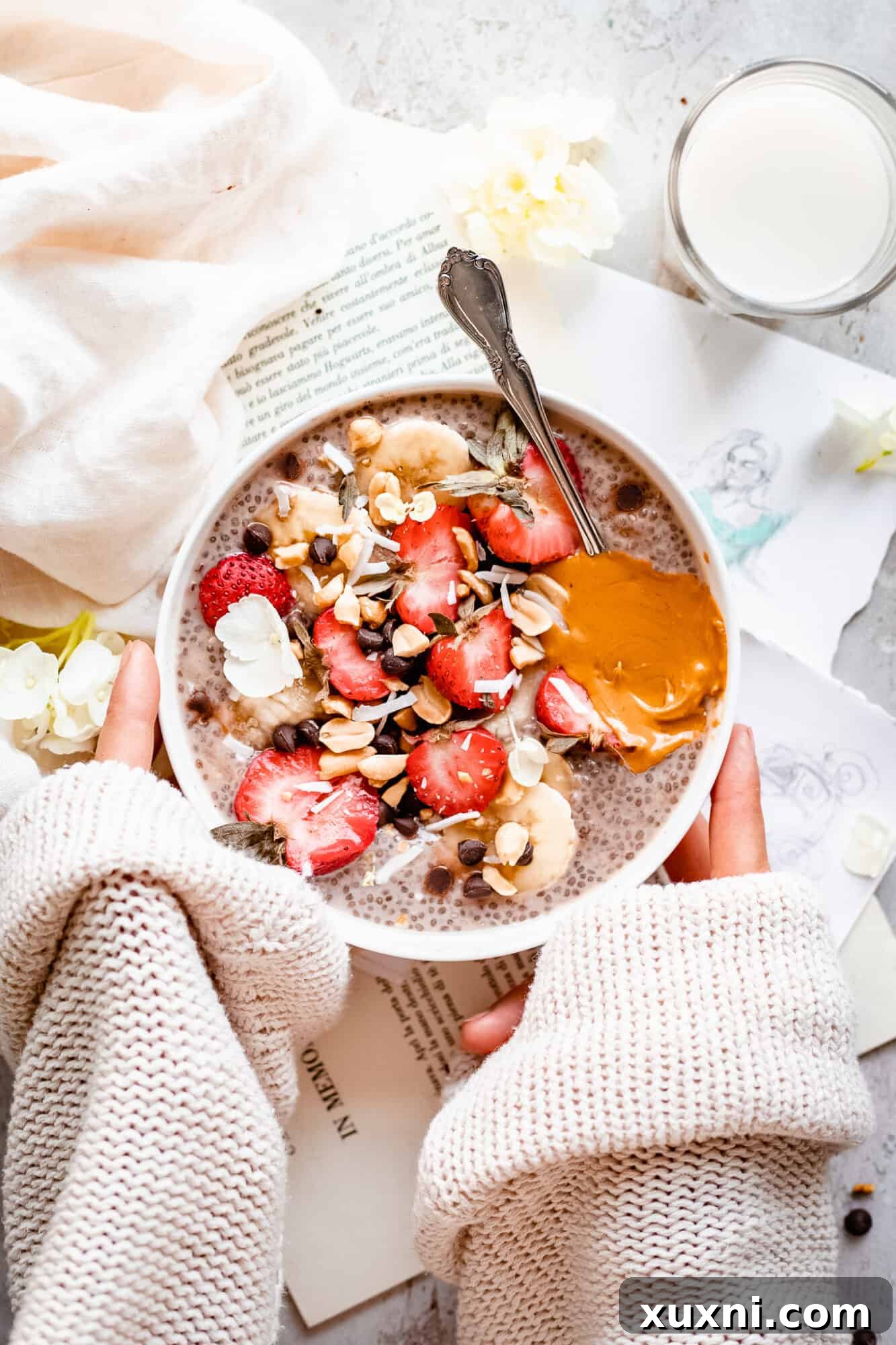 Hand holding a bowl of creamy chia pudding, ready to be enjoyed