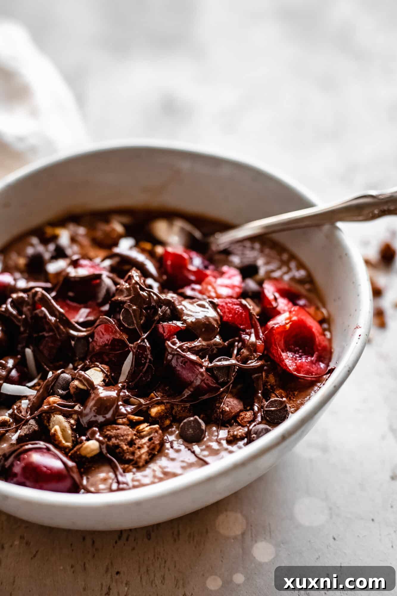 Close-up of a vibrant cherry chocolate chia pudding, garnished with fresh cherries