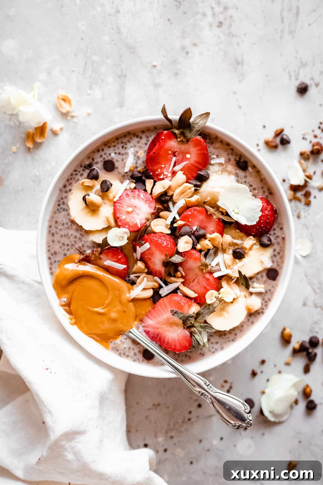 A simple, elegant bowl of protein chia pudding with a glass of milk in the background