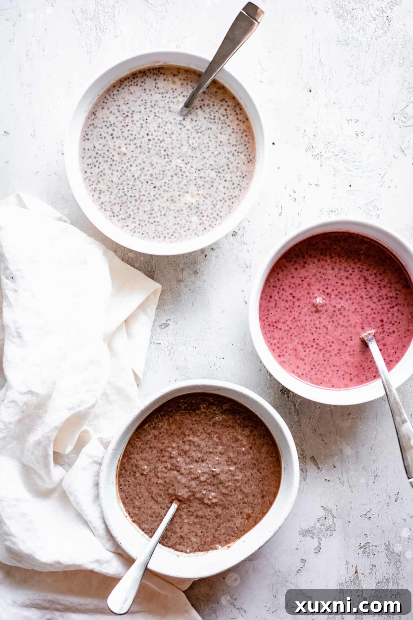Multiple bowls of chia pudding, ready for different toppings