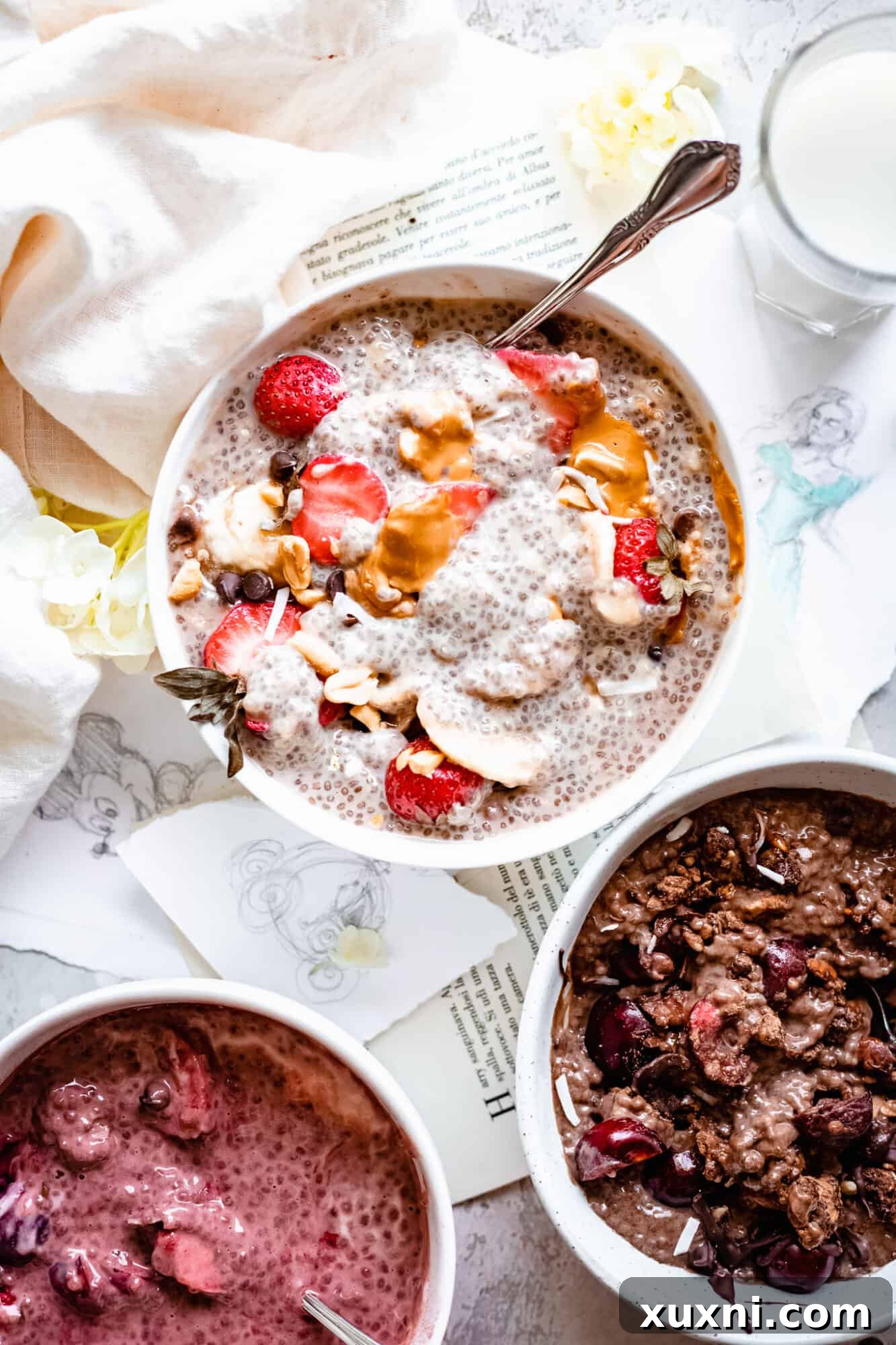 Assortment of bowls with different flavored chia puddings, beautifully topped