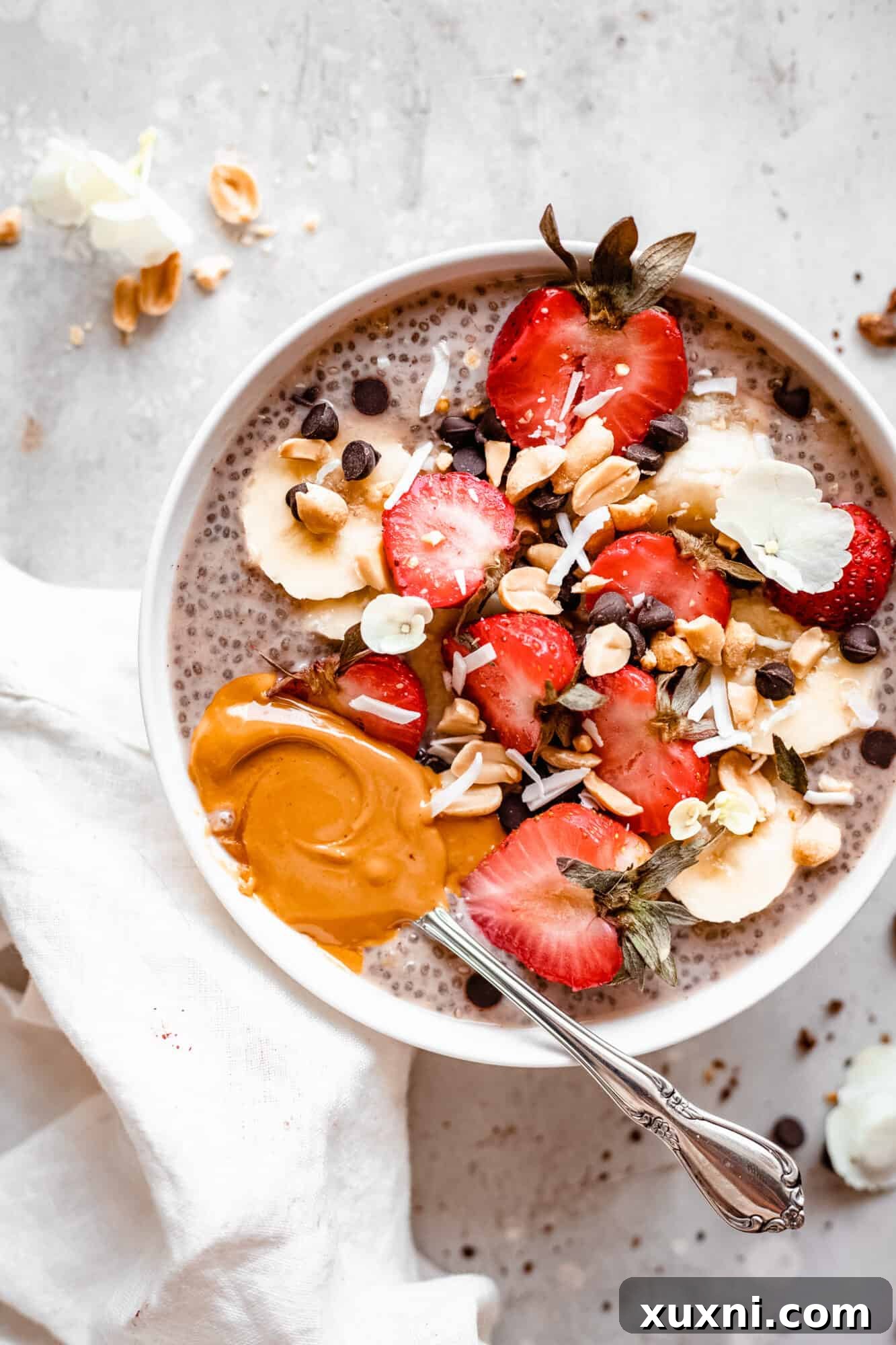Appealing bowl of banana chia pudding with slices of fresh banana and nuts