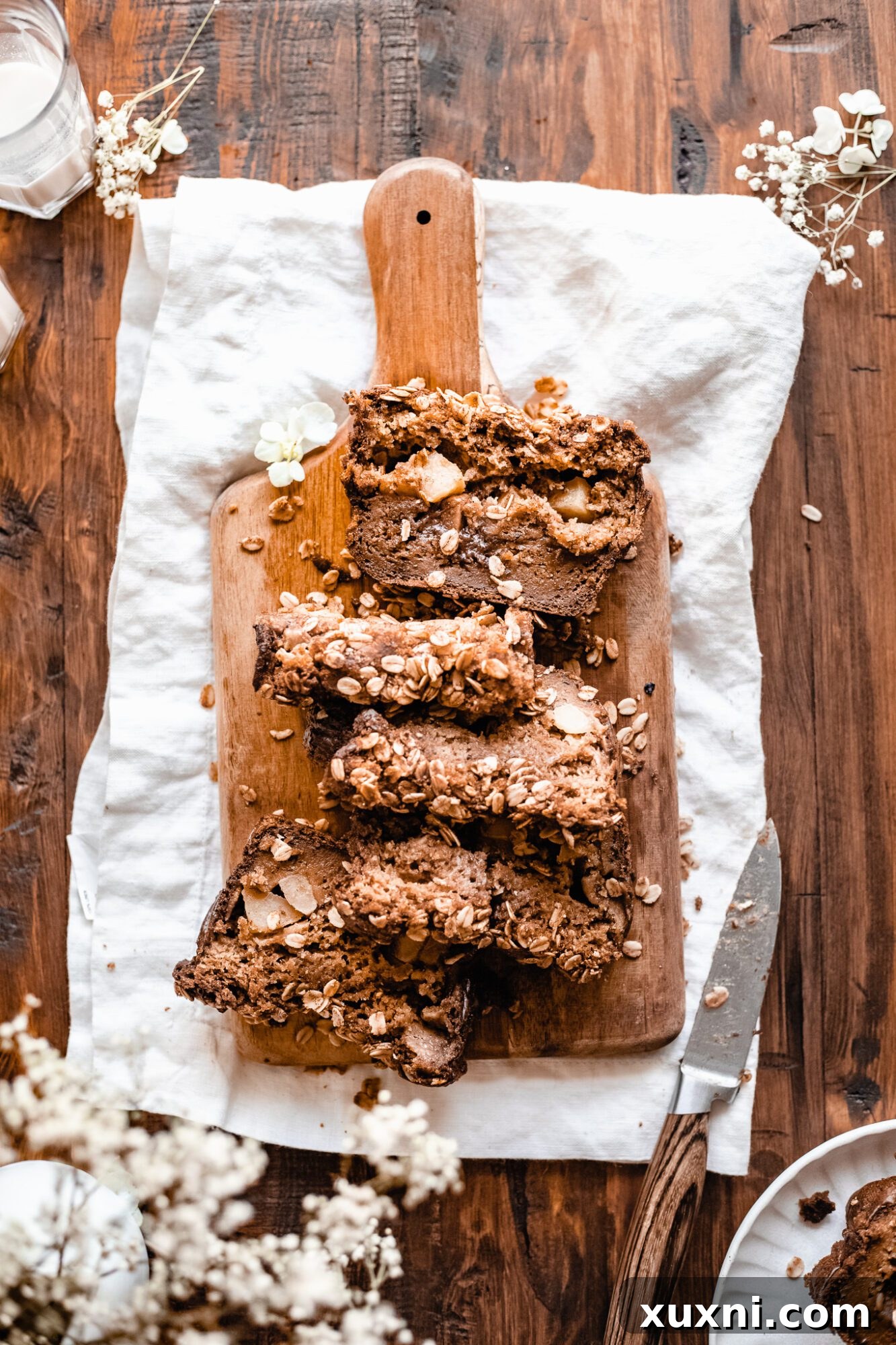 Beautifully sliced healthy vegan apple cinnamon bread on a wooden board, ready to be served.