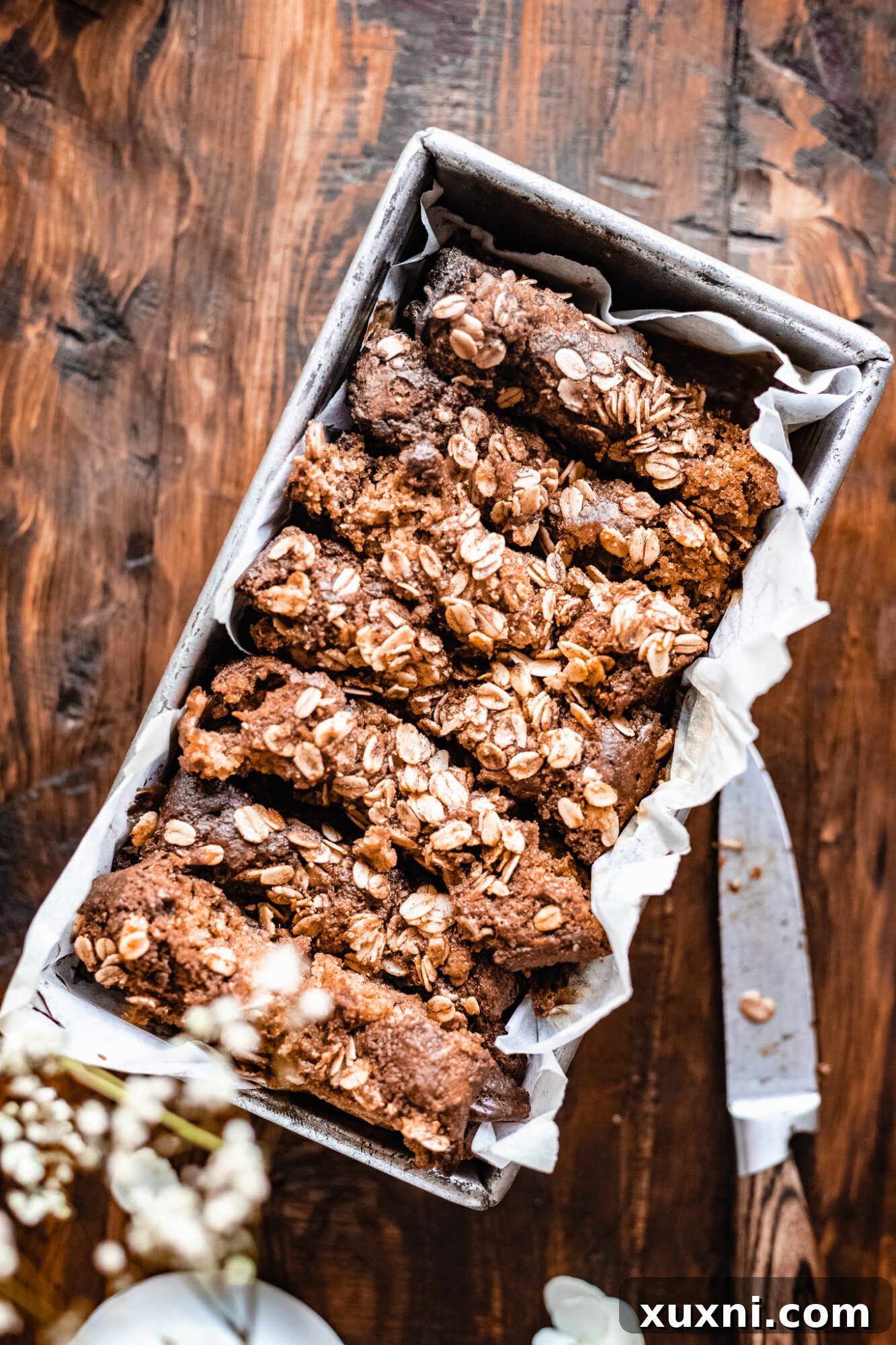 A stack of freshly sliced healthy vegan apple cinnamon bread on a white ceramic plate.
