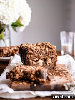 Slices of healthy vegan apple cinnamon bread on a rustic wooden board.