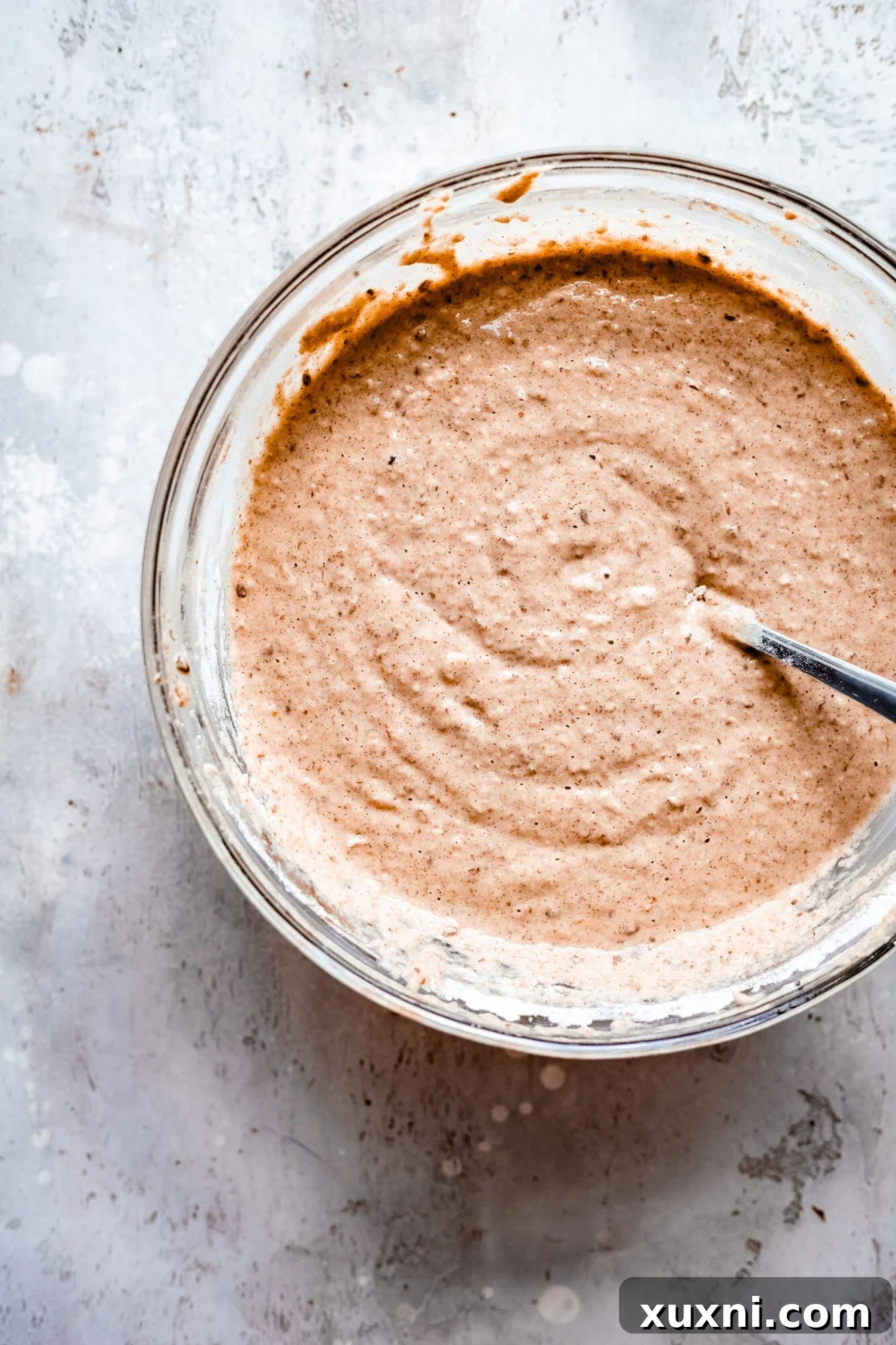 Thick, creamy batter for vegan apple bread being mixed in a bowl, ready for the apple filling.