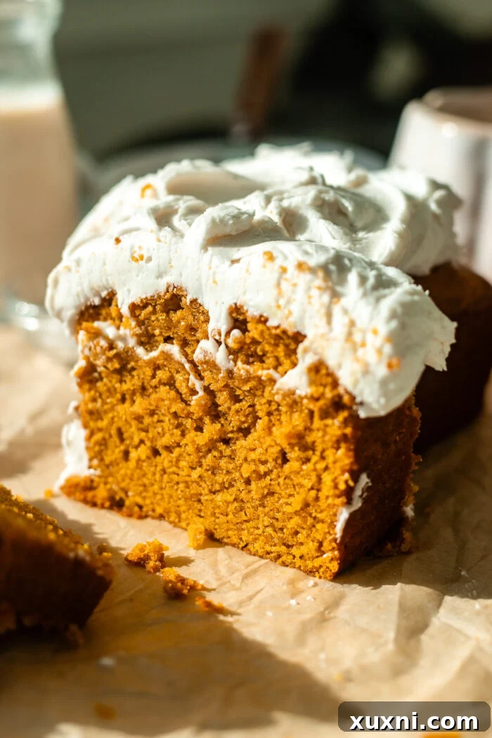 Incredibly Moist Vegan Pumpkin Bread Effortless One-Bowl Recipe 11 A stack of perfectly sliced vegan pumpkin bread, revealing its moist crumb and rich, spiced color.