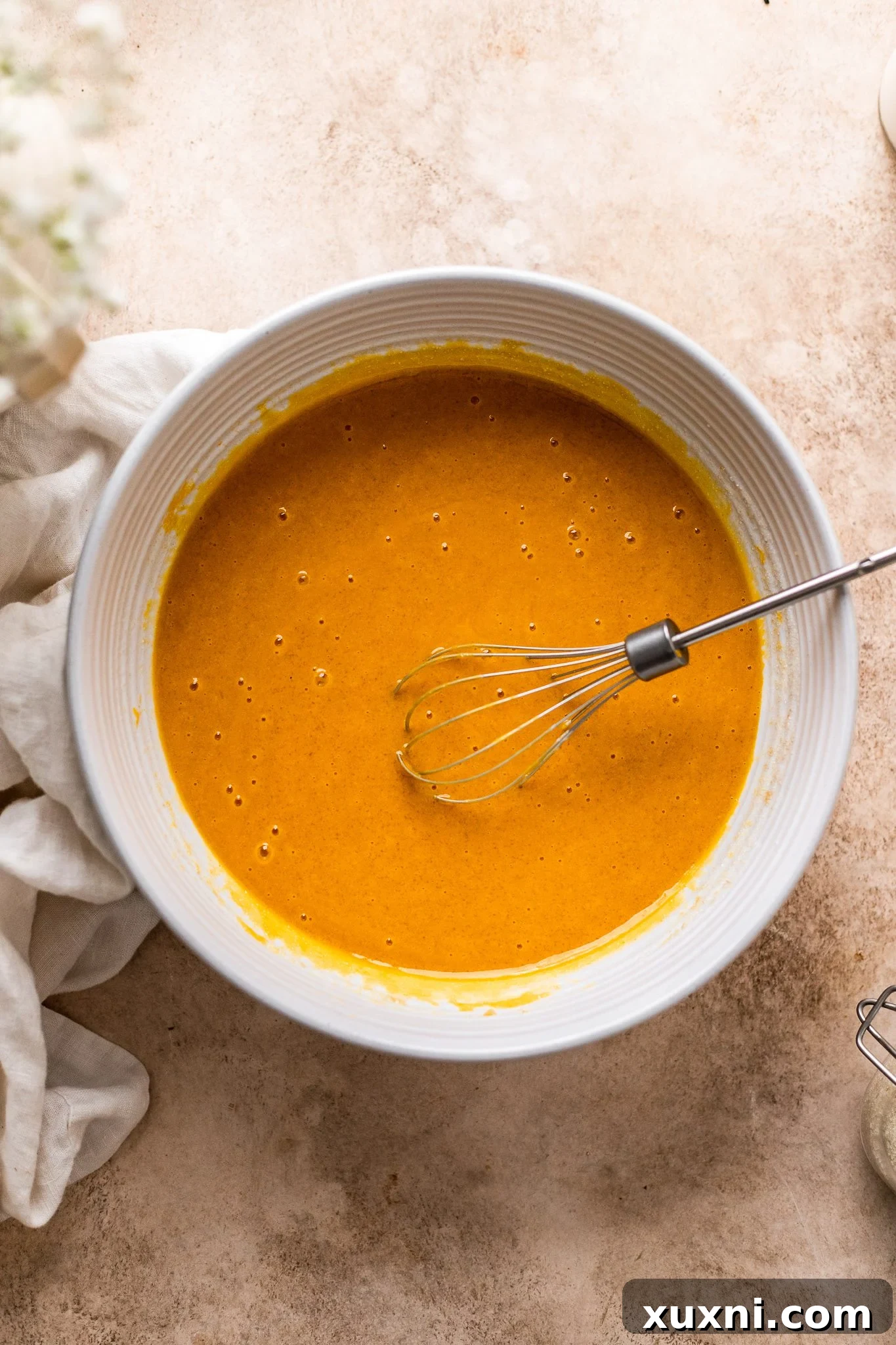 Incredibly Moist Vegan Pumpkin Bread Effortless One-Bowl Recipe 5 Wet ingredients for vegan pumpkin bread smoothly combined in a mixing bowl, ready for the dry ingredients.