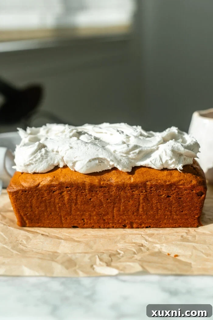 Incredibly Moist Vegan Pumpkin Bread Effortless One-Bowl Recipe 10 A beautifully frosted slice of vegan pumpkin bread, generously topped with creamy vegan cream cheese icing.