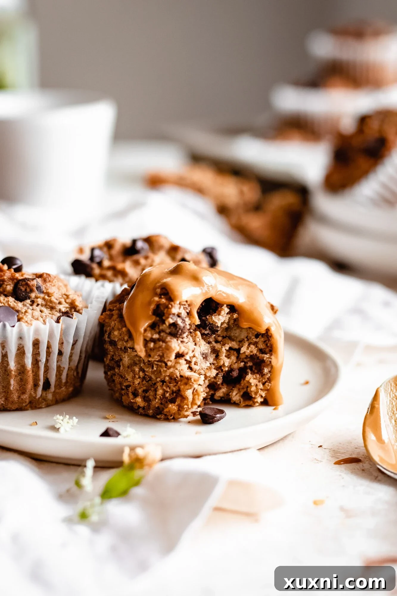 Healthy peanut butter muffin on plate with peanut butter on top