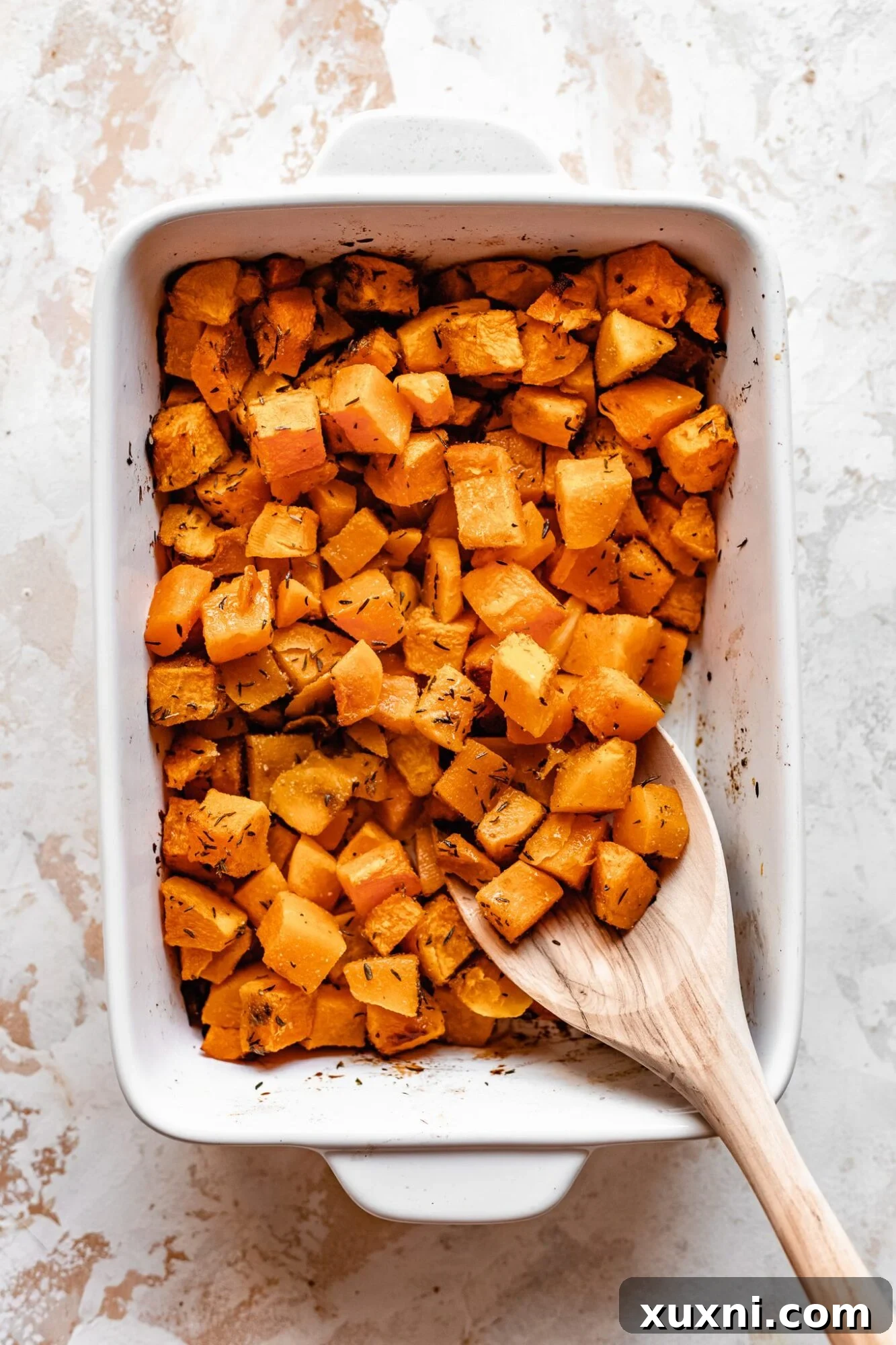 Effortless Golden Roasted Butternut Squash 2 Butternut squash roasted to golden perfection in a casserole dish, ready to be served as a healthy fall side