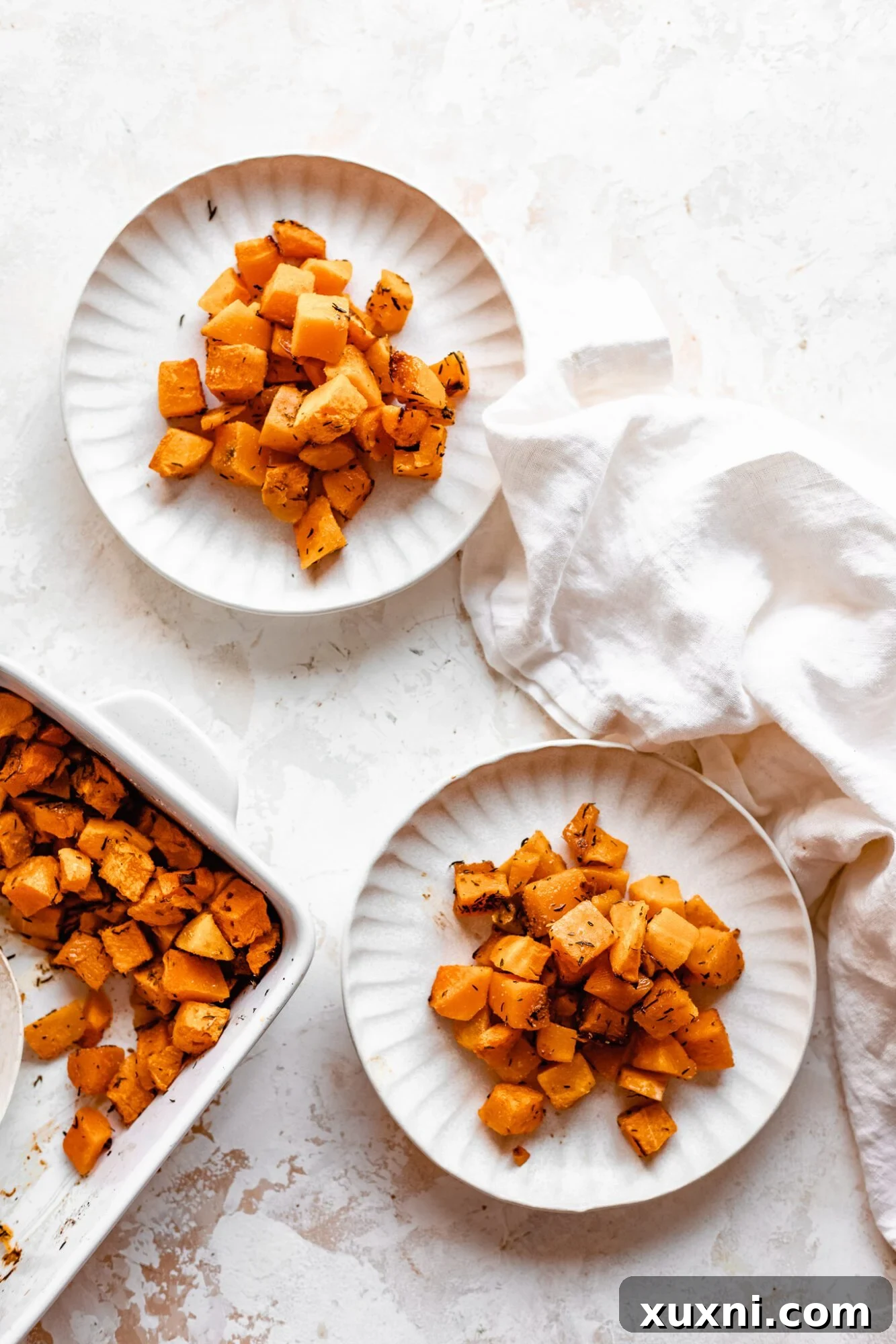 Effortless Golden Roasted Butternut Squash 4 Three plates featuring perfectly roasted butternut squash, highlighting its versatility as a side dish