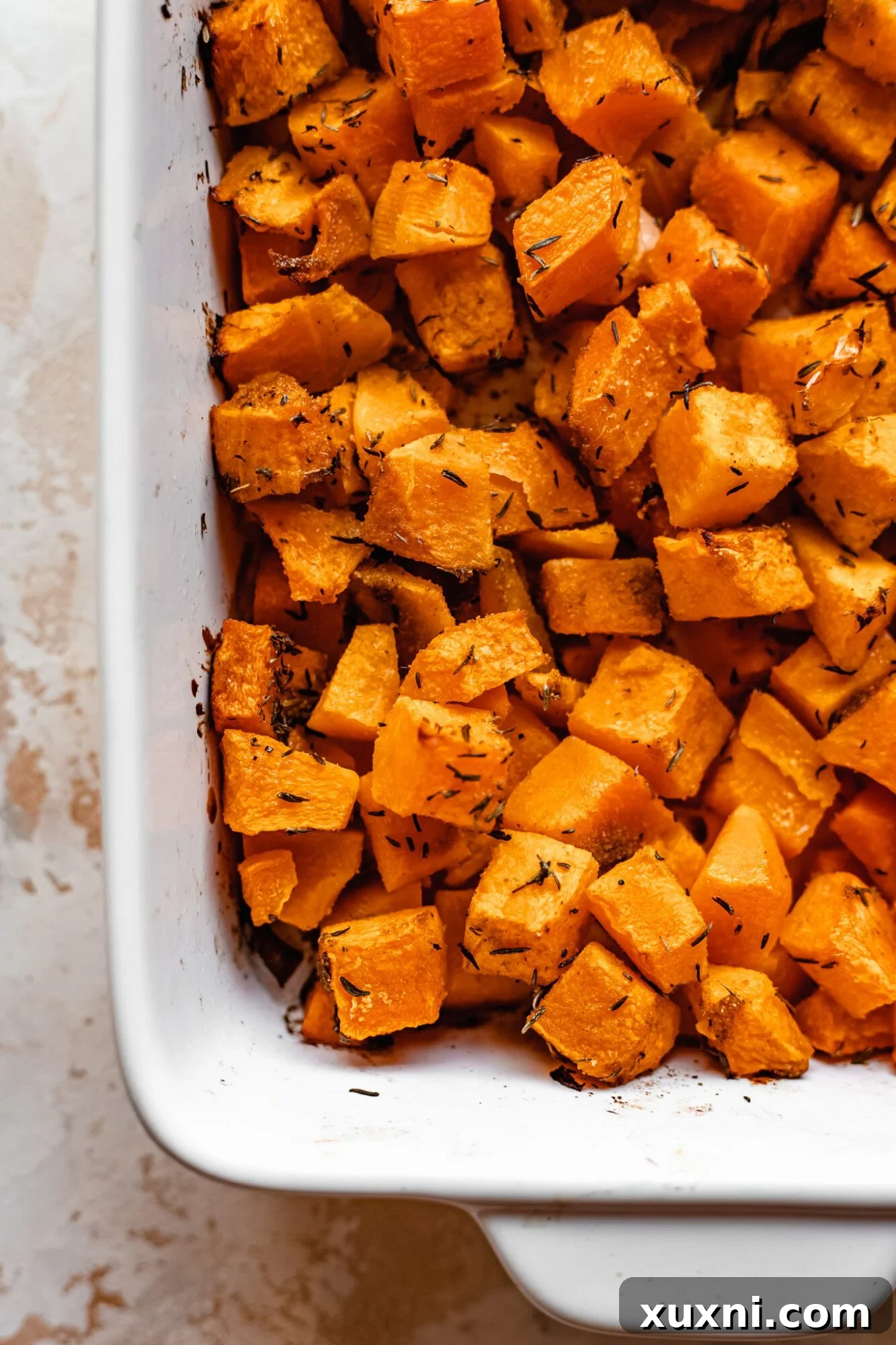 Effortless Golden Roasted Butternut Squash 5 Close-up view of perfectly roasted butternut squash cubes, showcasing their golden-brown edges and tender texture