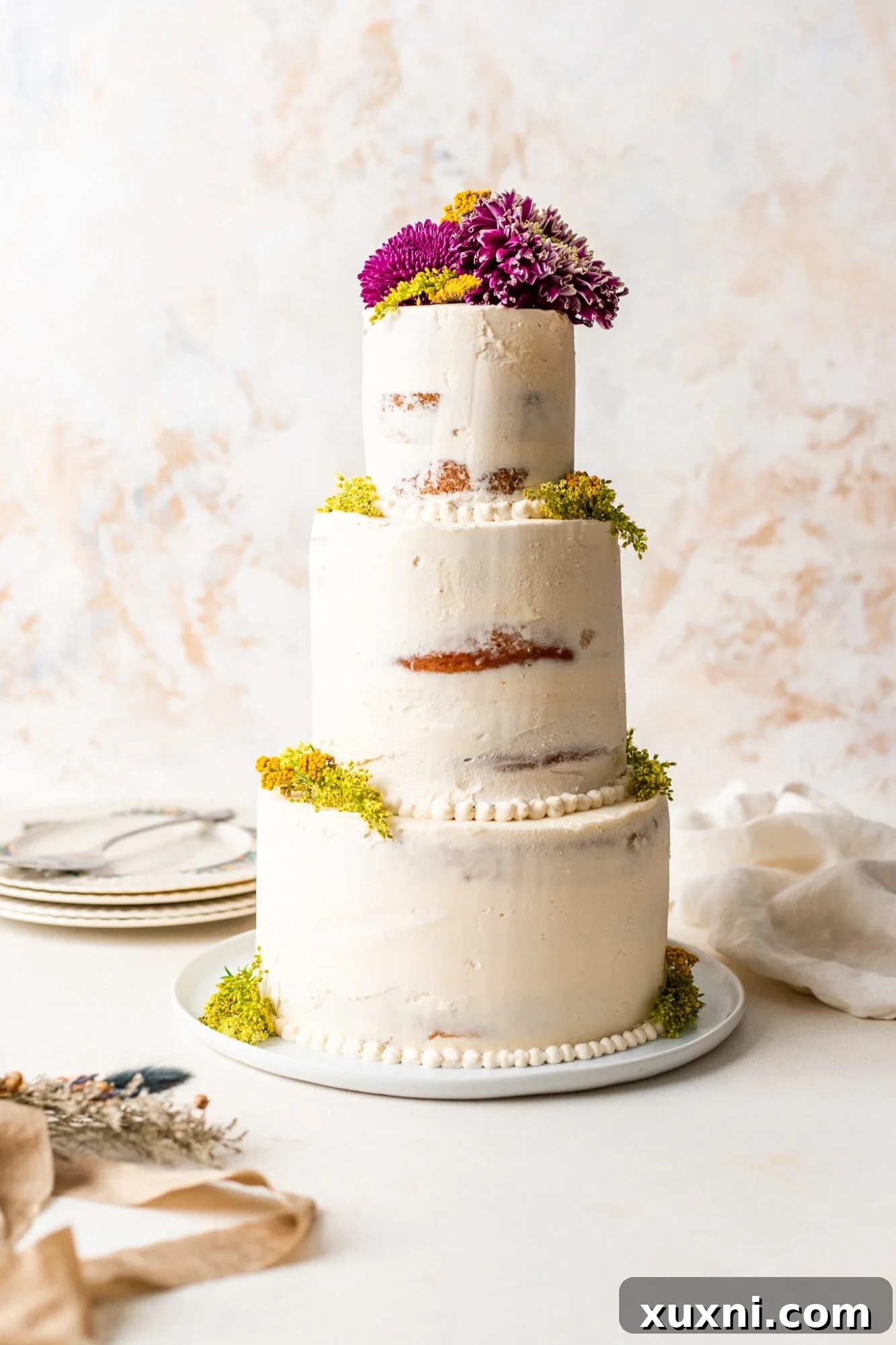 Homemade Vegan Wedding Cake - a beautiful multi-tier vegan cake decorated with fresh flowers, perfect for a wedding